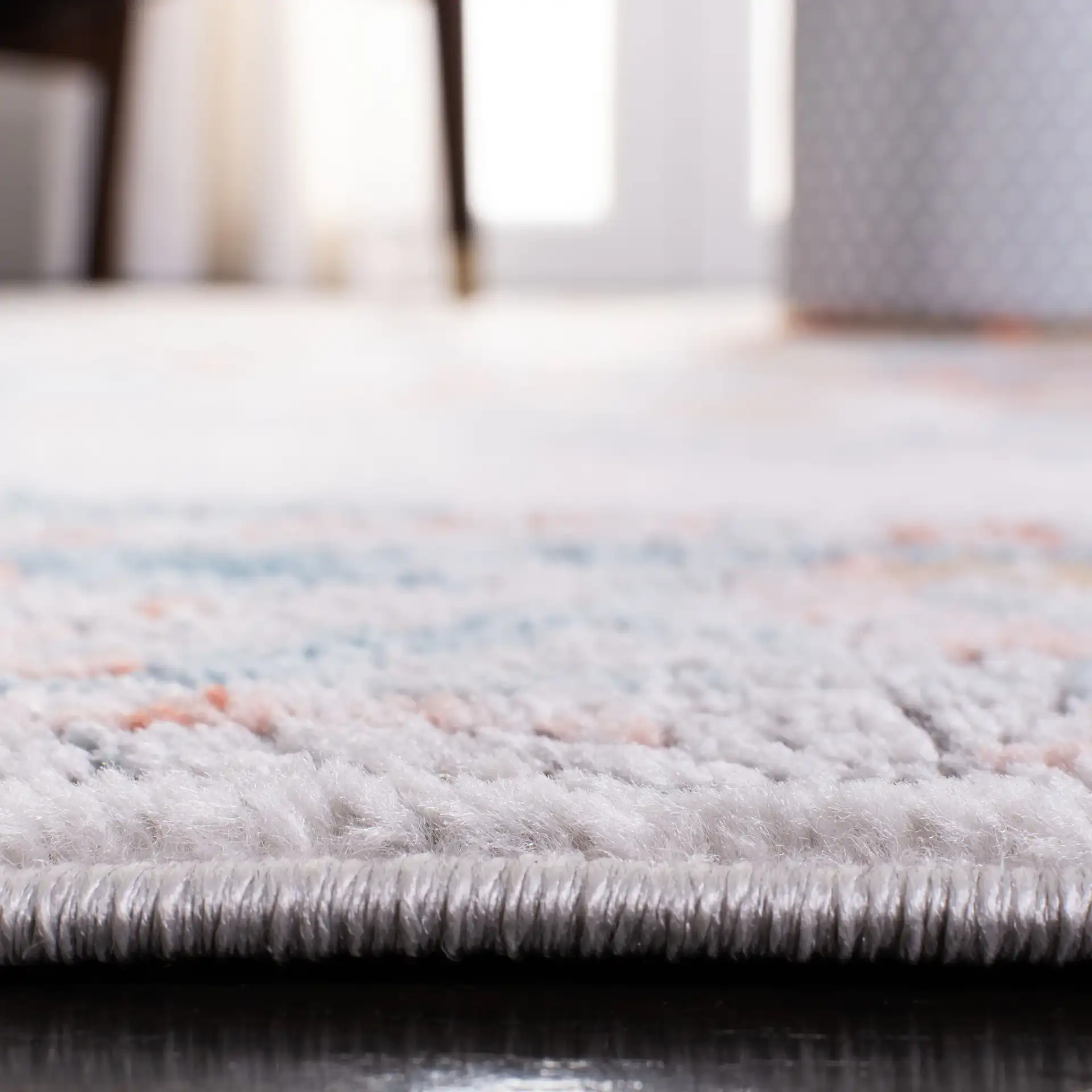 Shivan Medallion Bordered Rug in Gray / Blue in a styled room