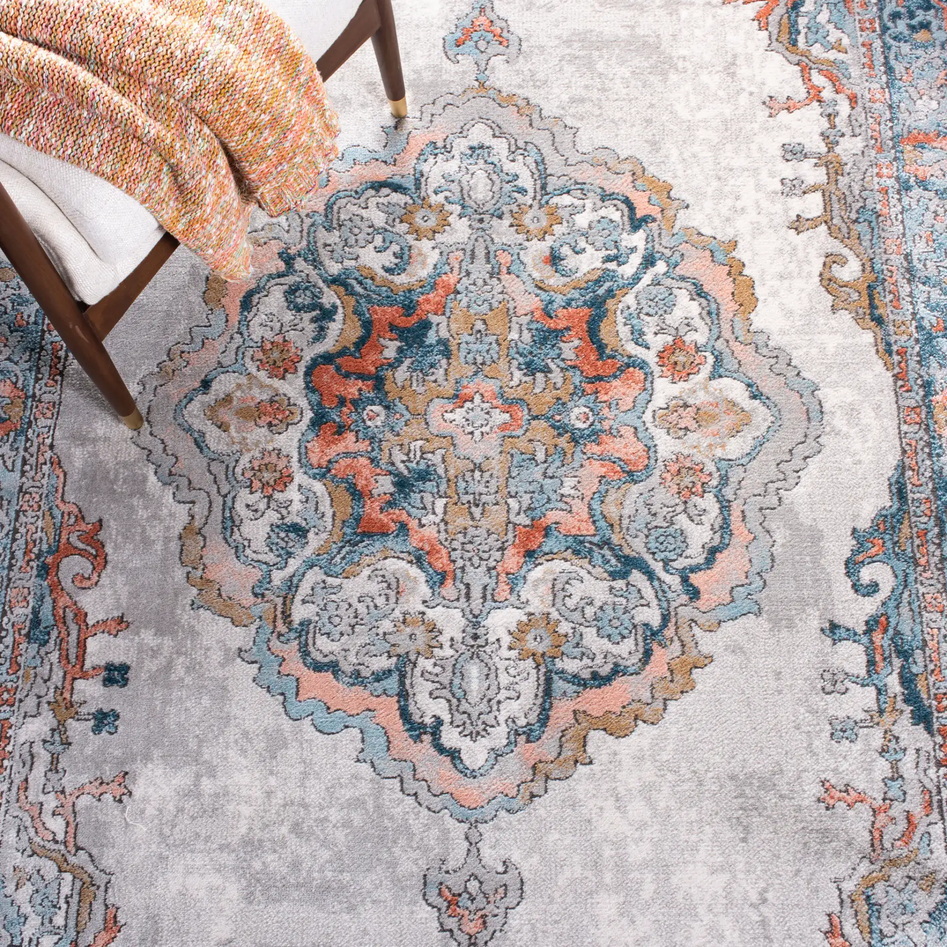 Shivan Medallion Bordered Rug in Gray / Blue in a styled room