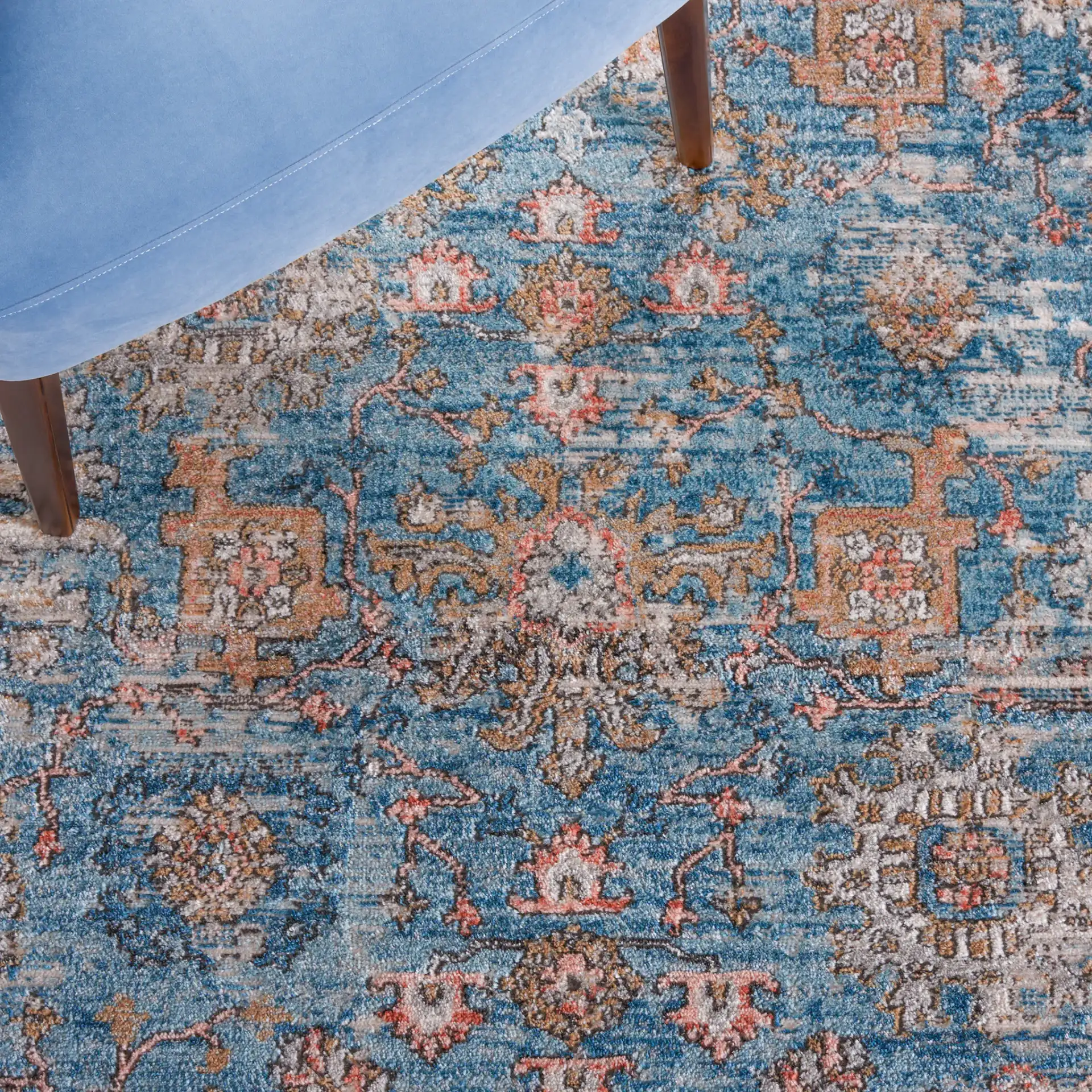 Shivan Bordered Floral Rug in Blue / Red in a styled room