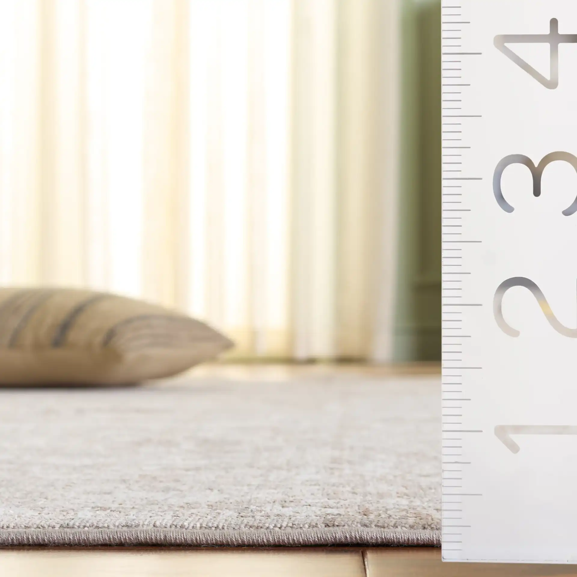 Signature Faded Bordered Floral Rug in Beige / Gray in a styled room