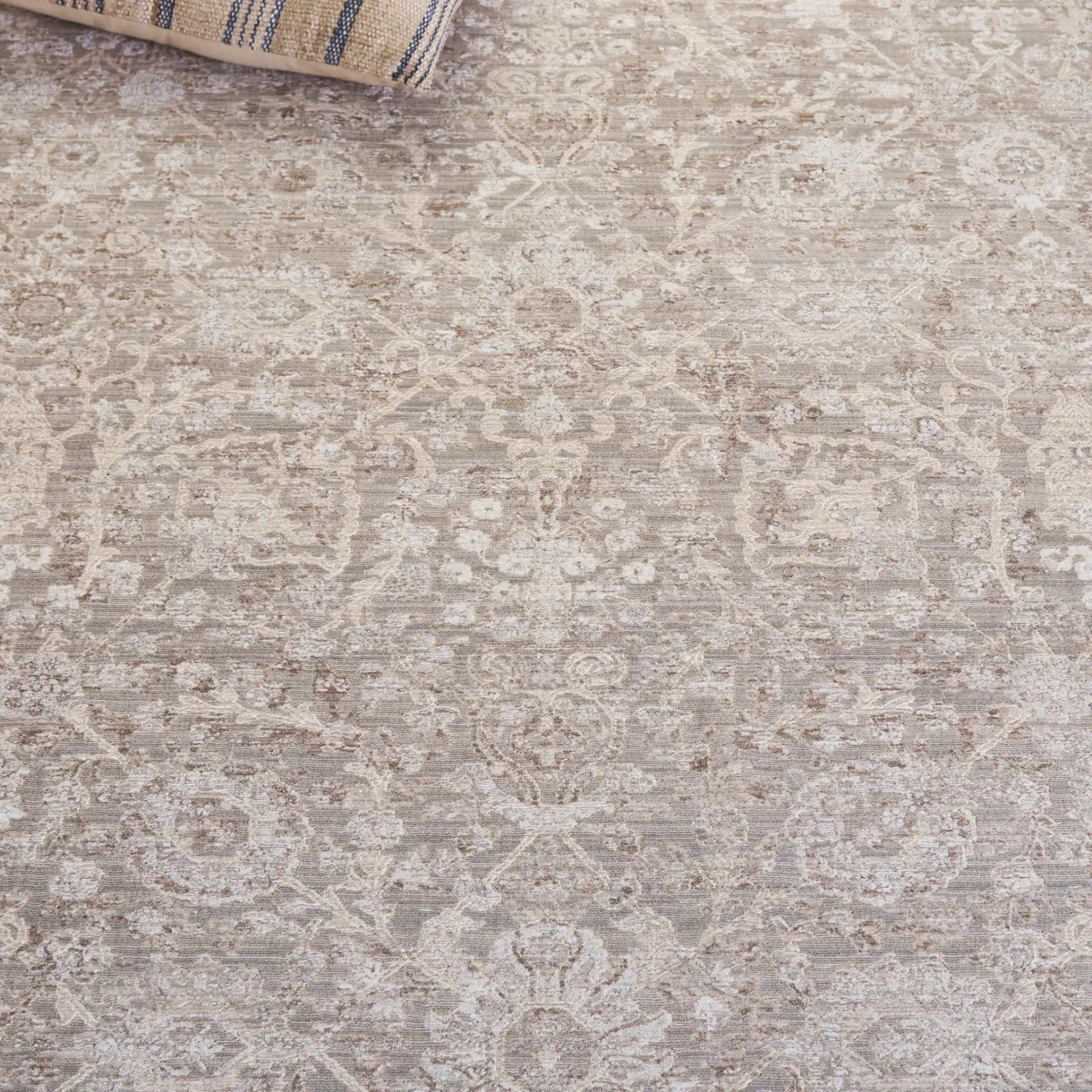 Signature Faded Bordered Floral Rug in Beige / Gray in a styled room