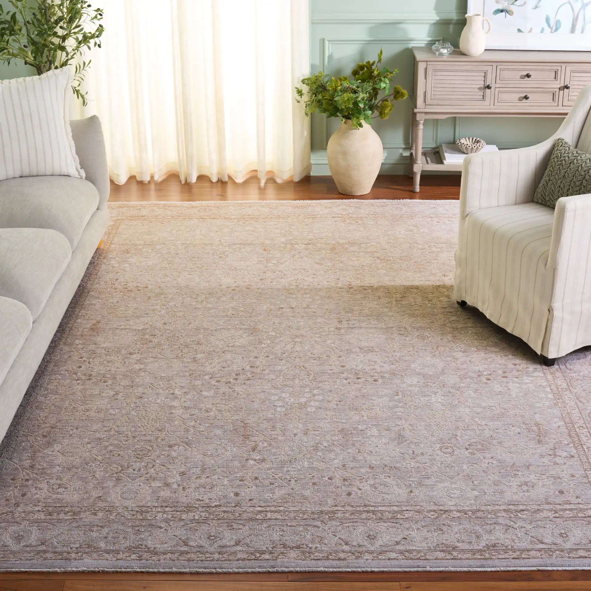 Signature Faded Bordered Floral Rug in Beige / Gray in a styled room