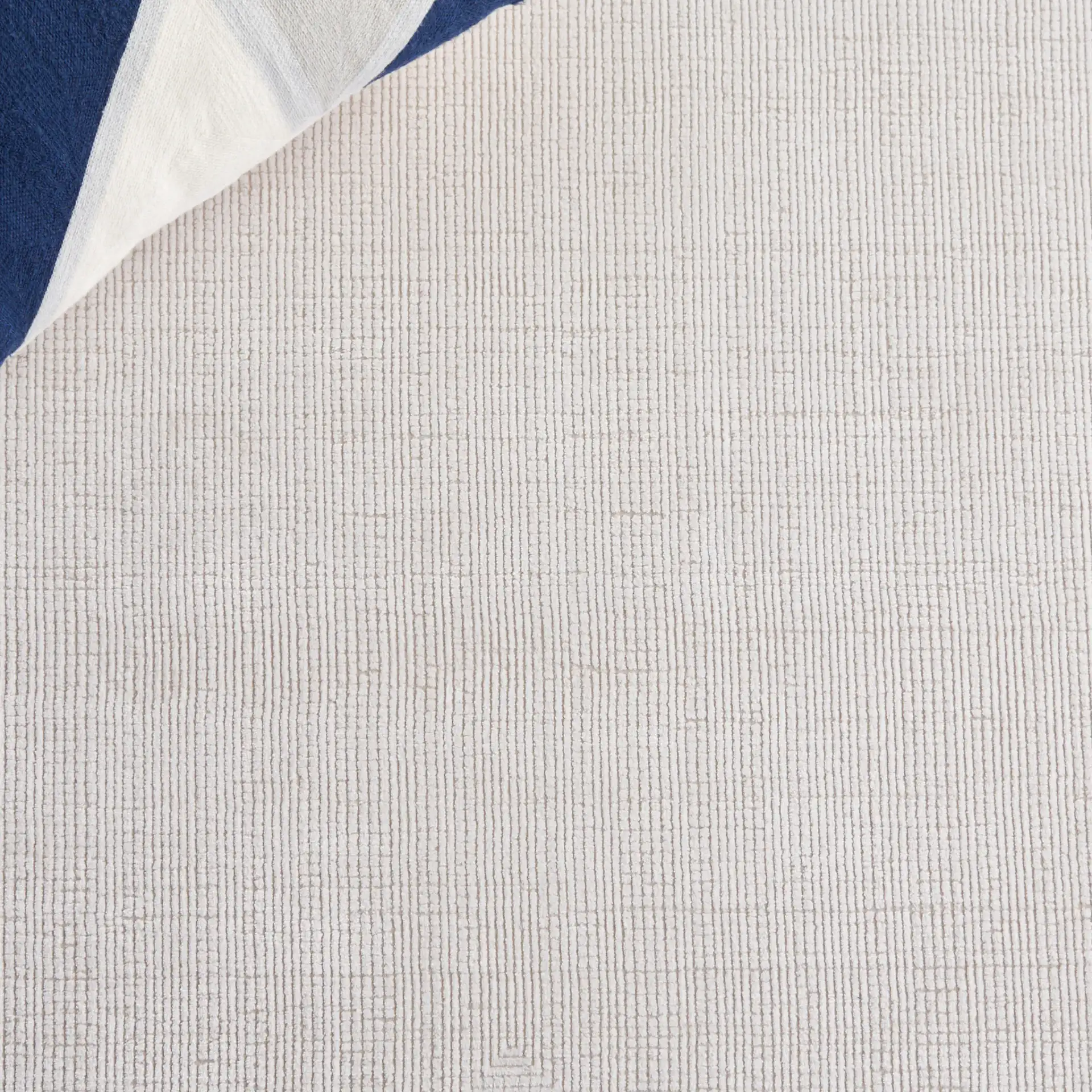 Signature Silken Solid Ribbed Rug in Ivory in a styled room