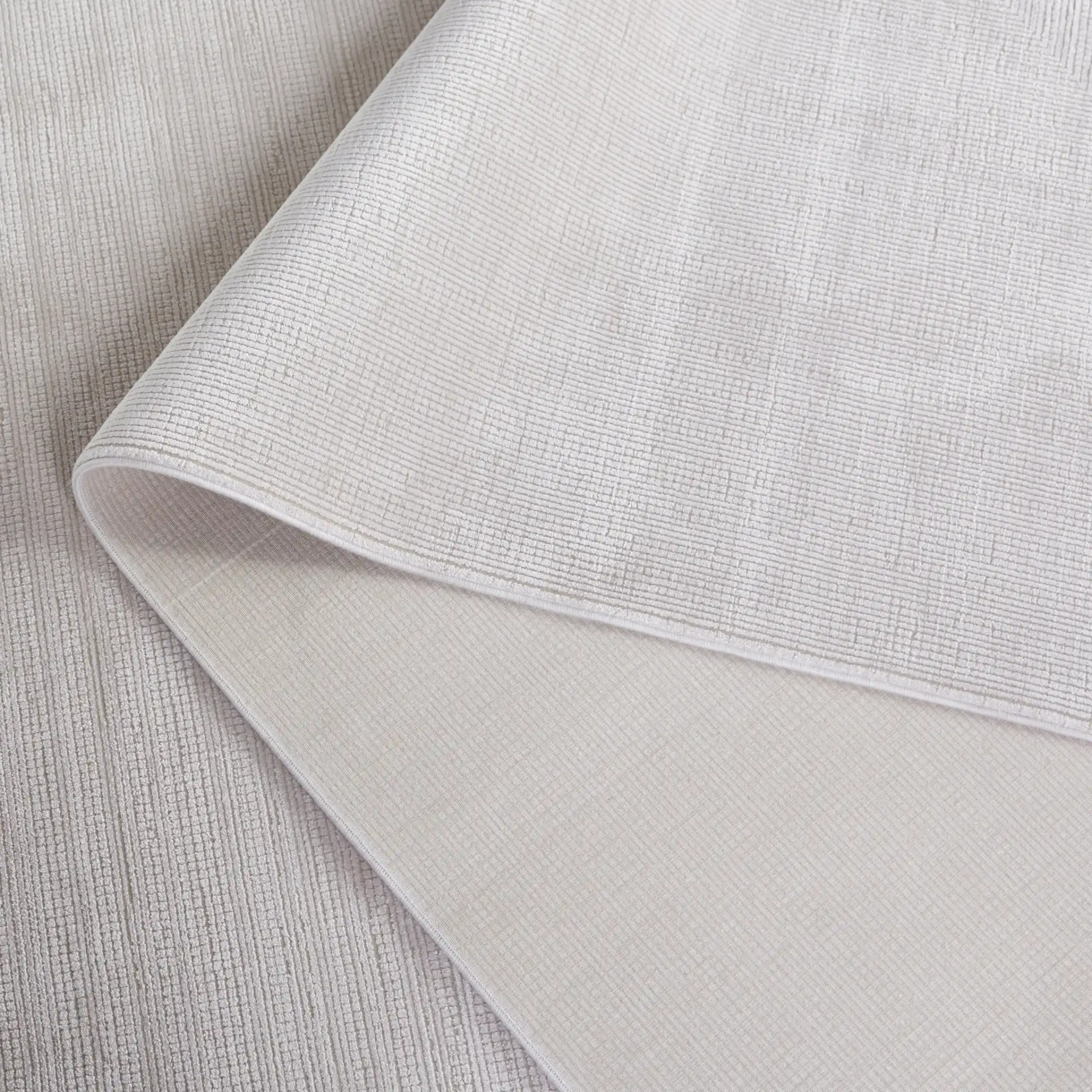 Signature Silken Solid Ribbed Rug in Ivory in a styled room