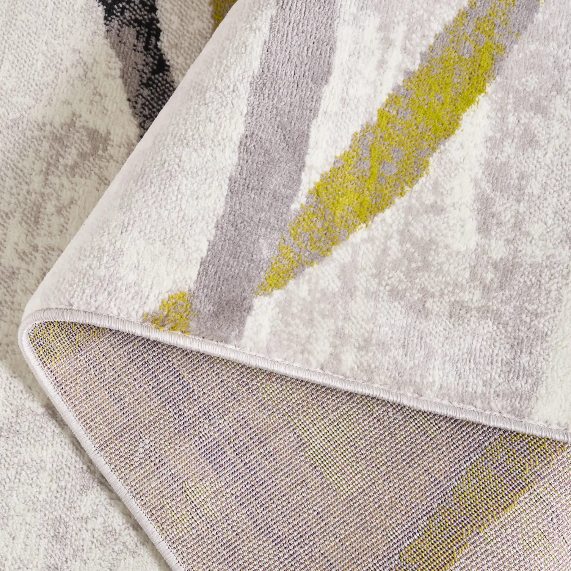 Skyler Abstract Wave Rug in Ivory Gray / Green in a styled room