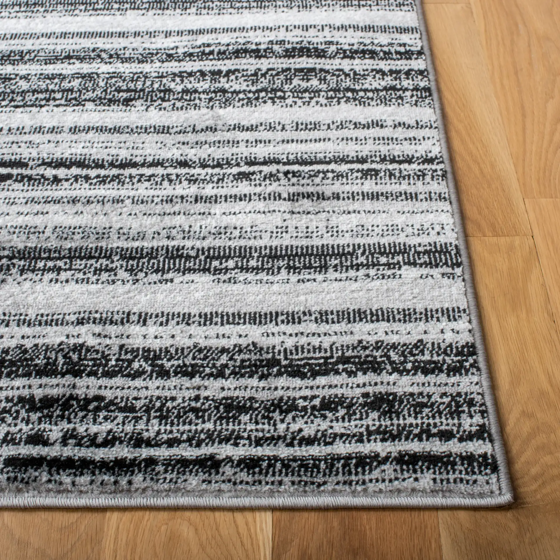Skyler Striped Rug in Gray / Black in a styled room