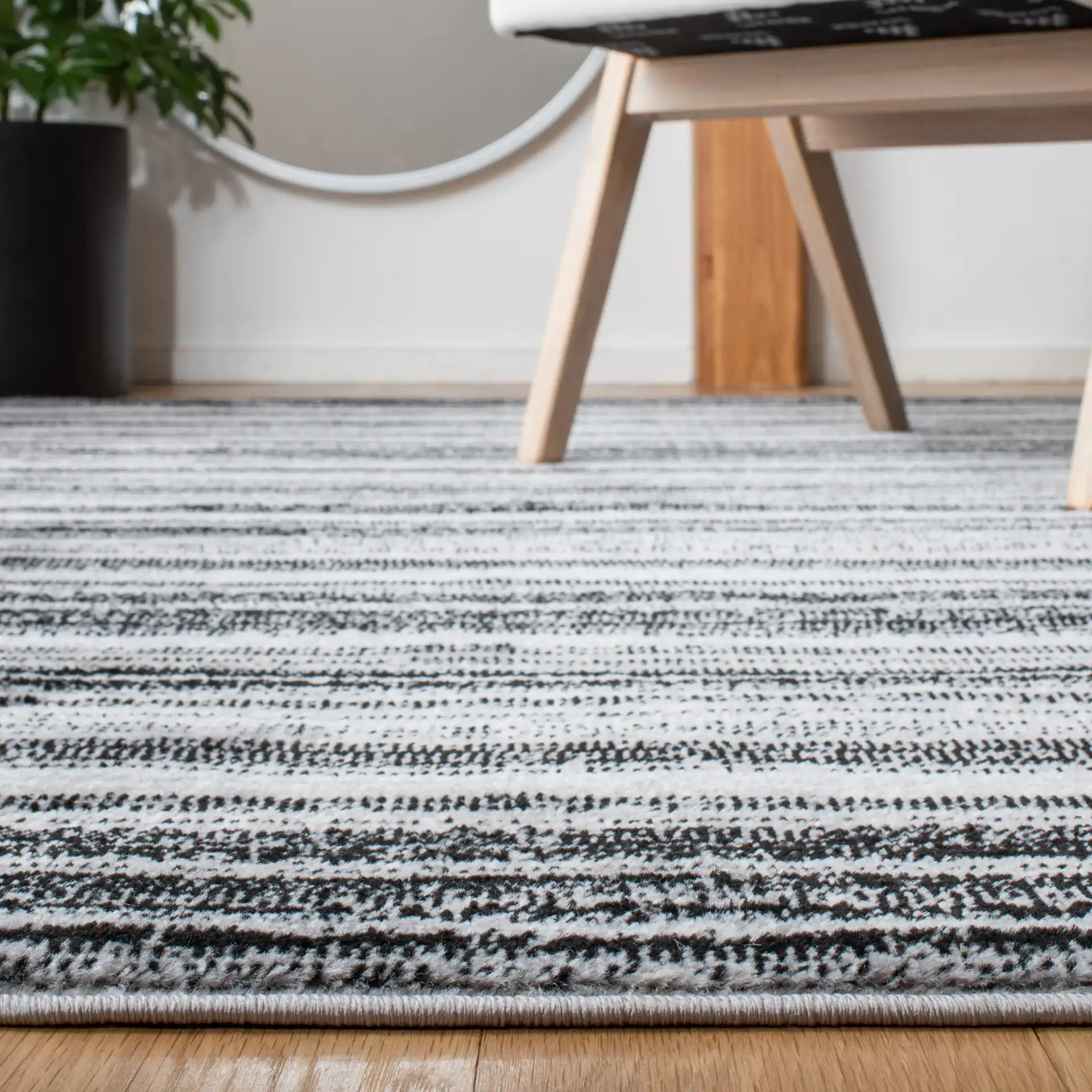 Skyler Striped Rug in Gray / Black in a styled room
