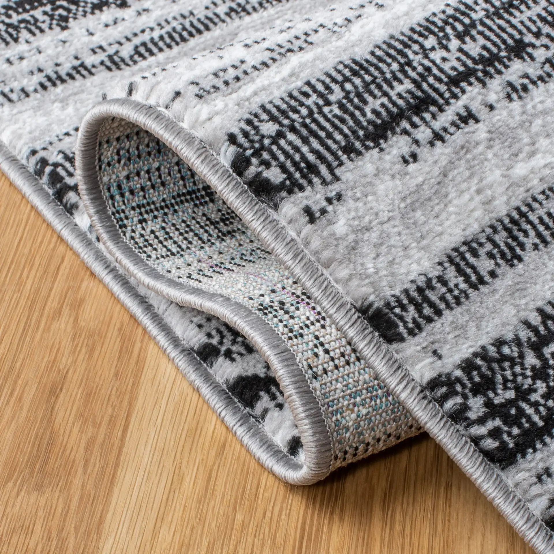 Skyler Striped Rug in Gray / Black in a styled room