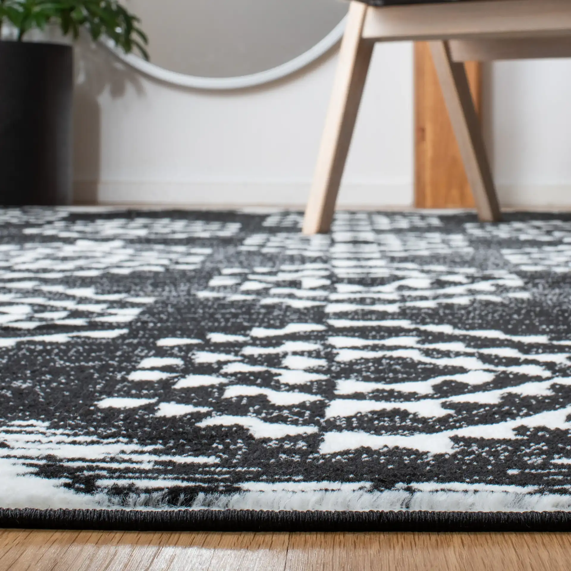 Skyler Nested Diamond Rug in Black / Ivory in a styled room