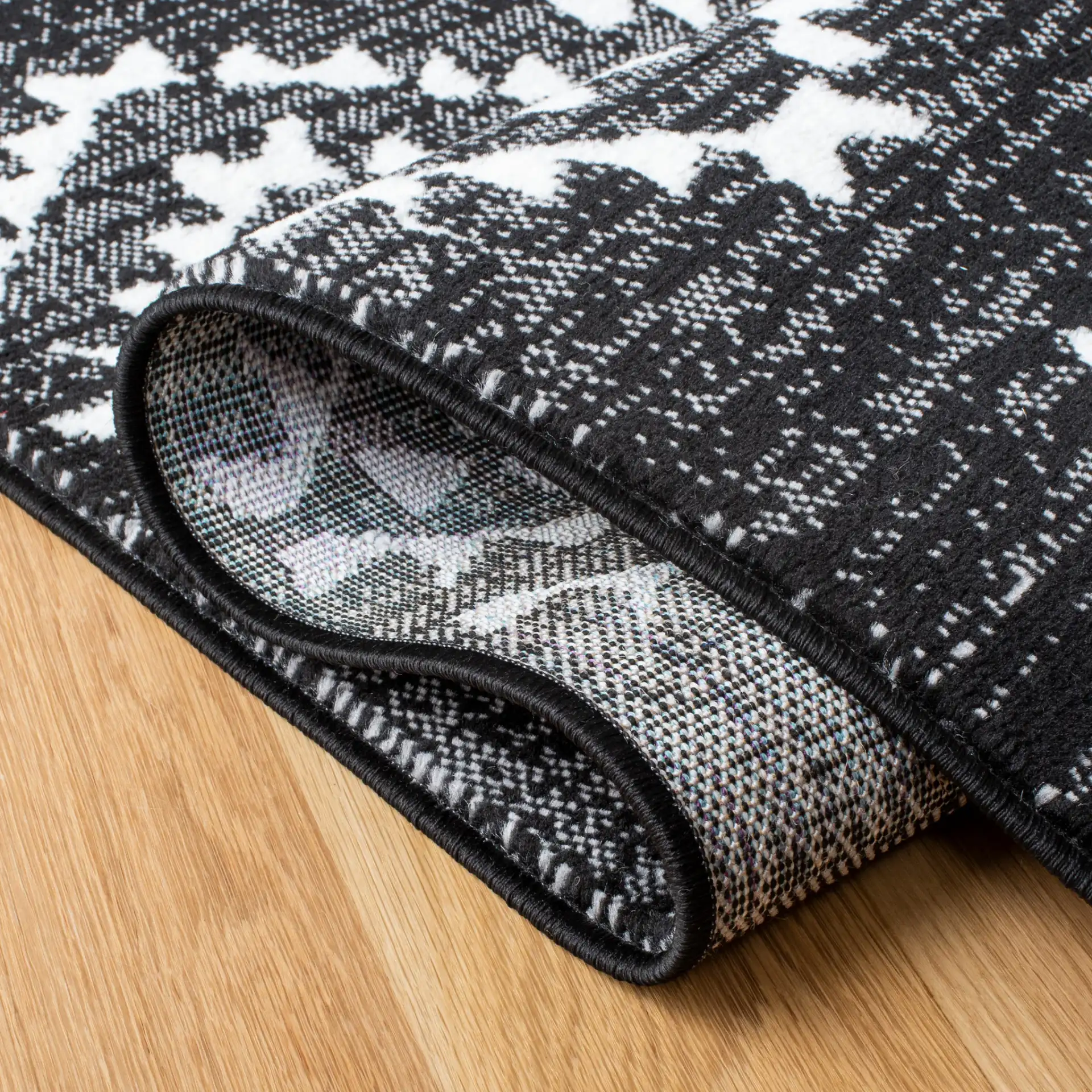 Skyler Nested Diamond Rug in Black / Ivory in a styled room