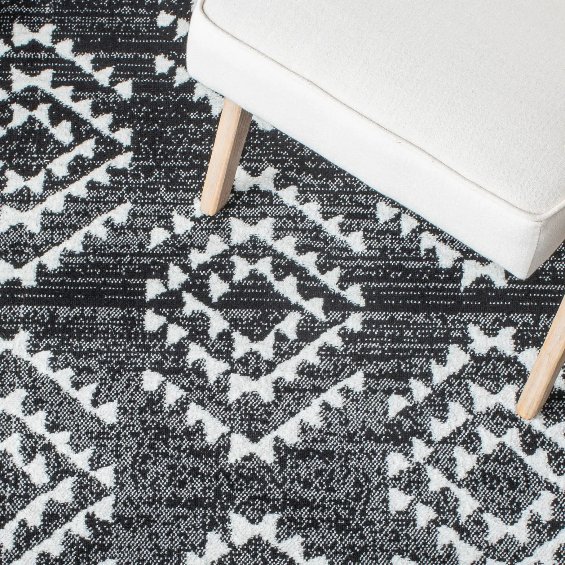 Skyler Nested Diamond Rug in Black / Ivory in a styled room