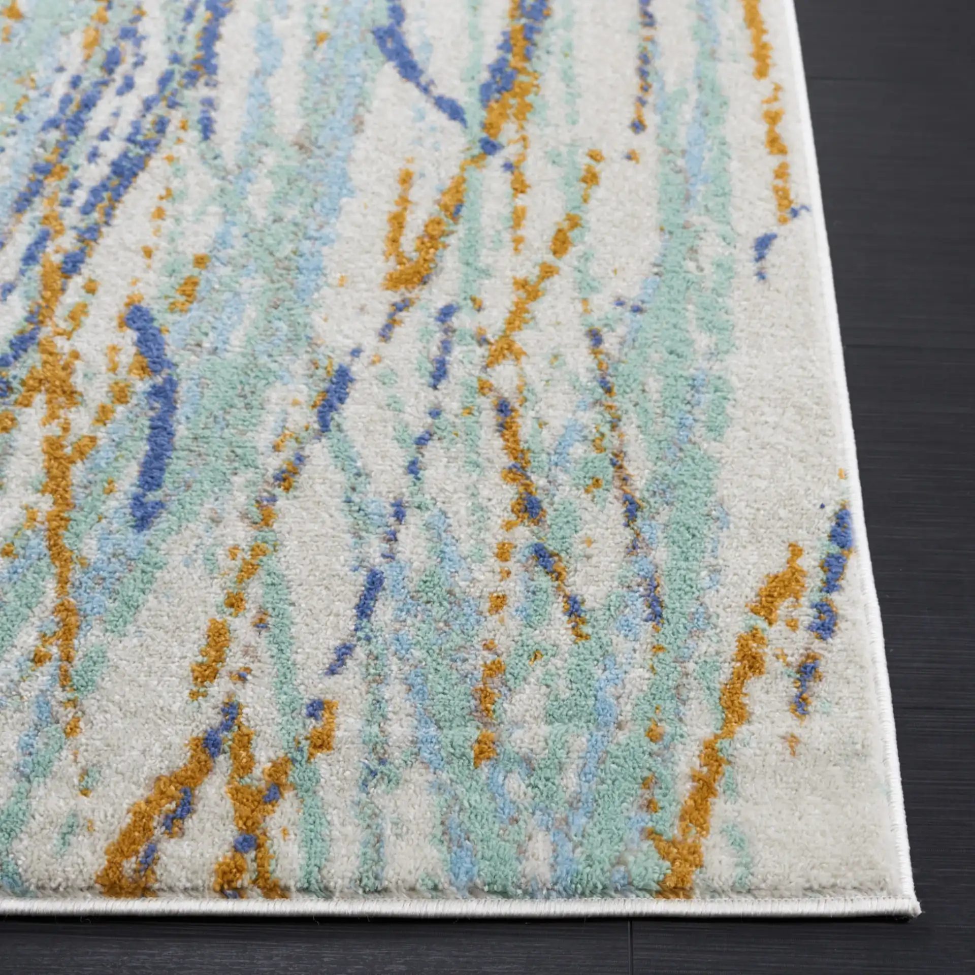 Skyler Abstract Dappled Linear Rug in Gold / Blue Green in a styled room