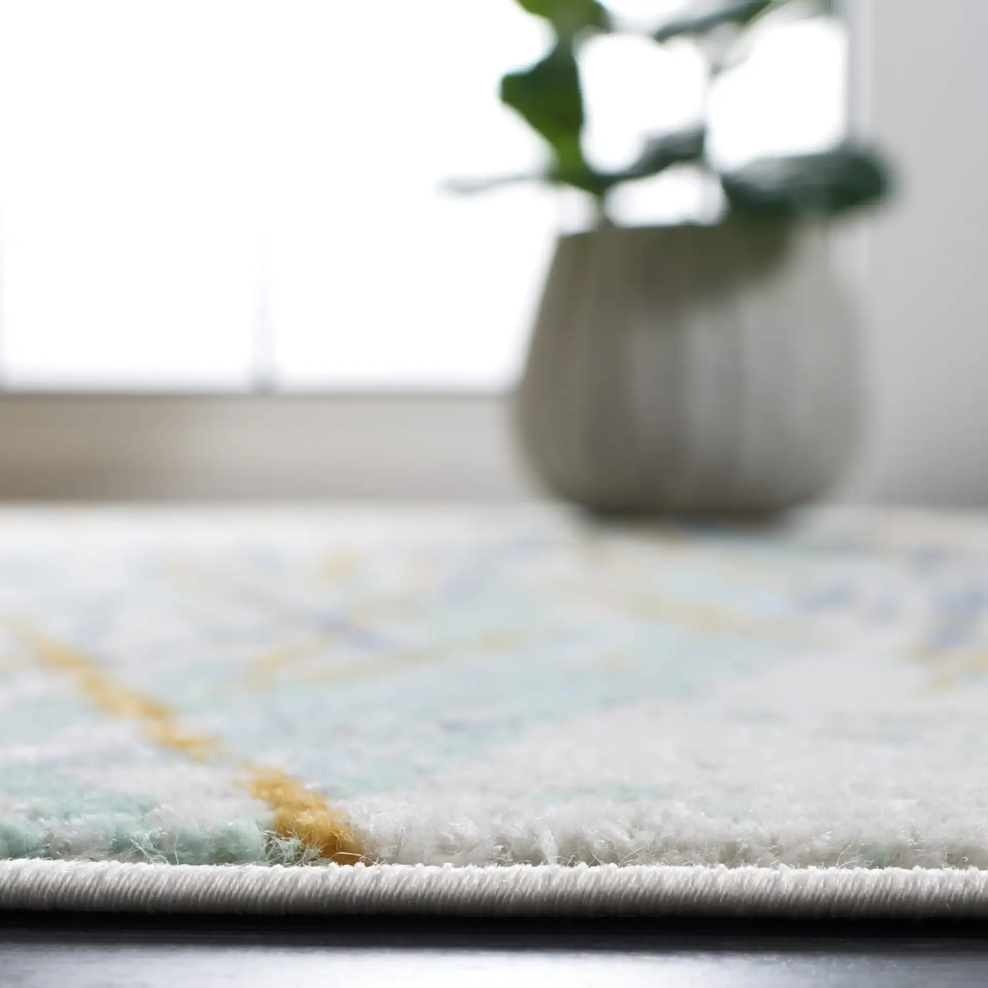 Skyler Abstract Dappled Linear Rug in Gold / Blue Green in a styled room