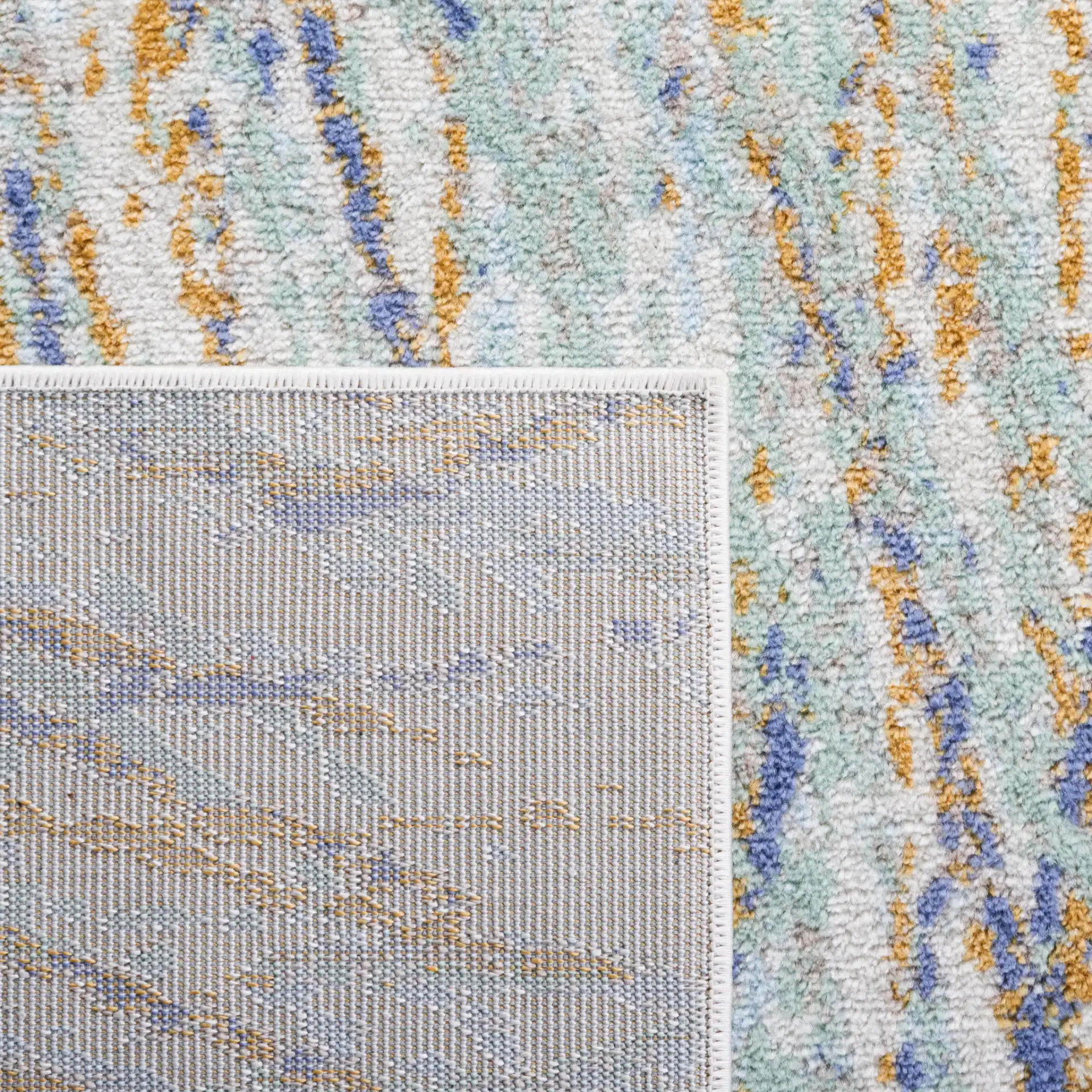 Skyler Abstract Dappled Linear Rug in Gold / Blue Green in a styled room