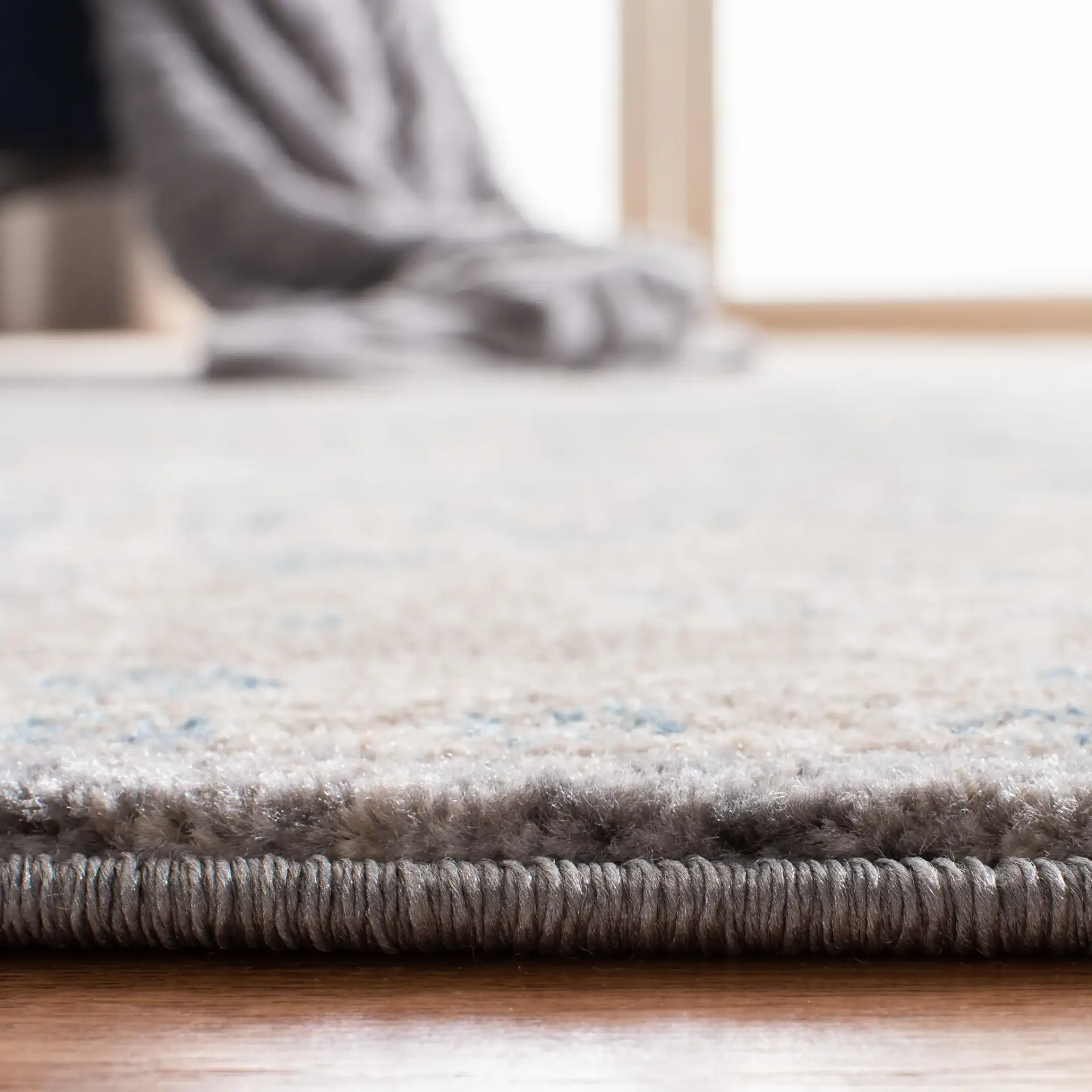 Sofia Allover Floral Bordered Rug in Light Gray / Beige in a styled room