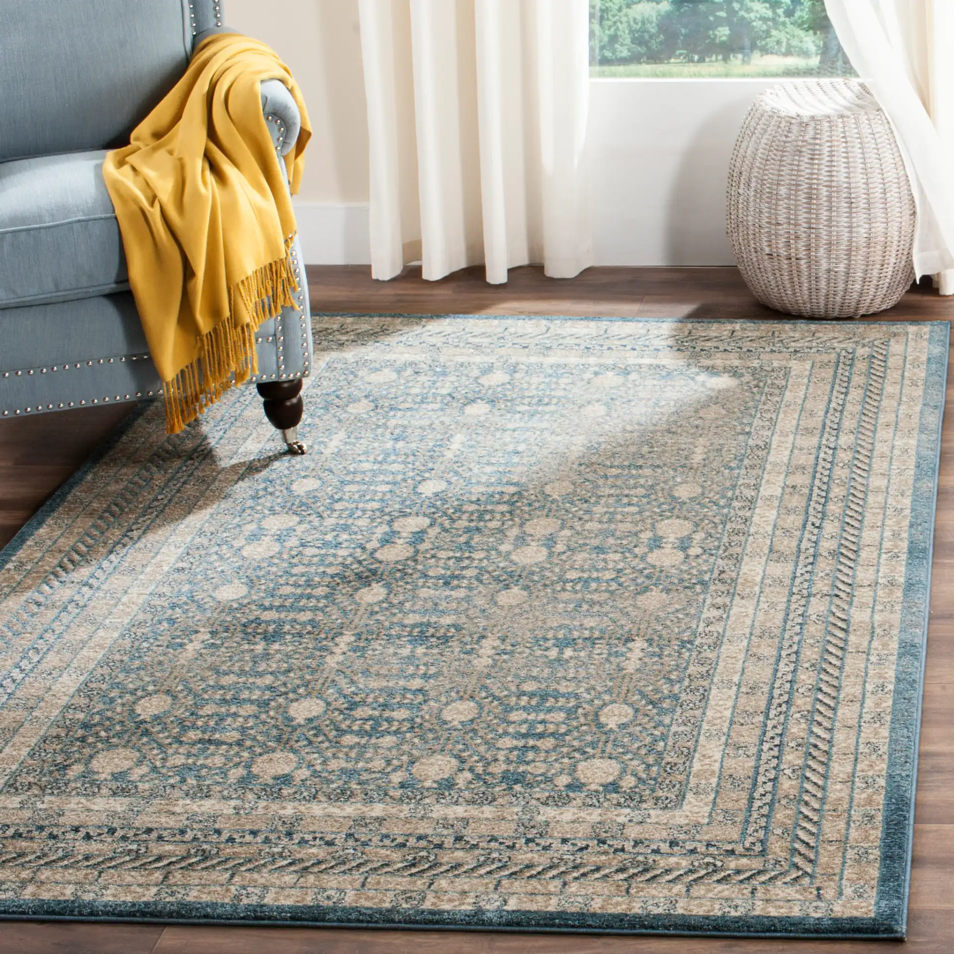 Sofia Bordered Floral Rug in Blue / Beige in a styled room