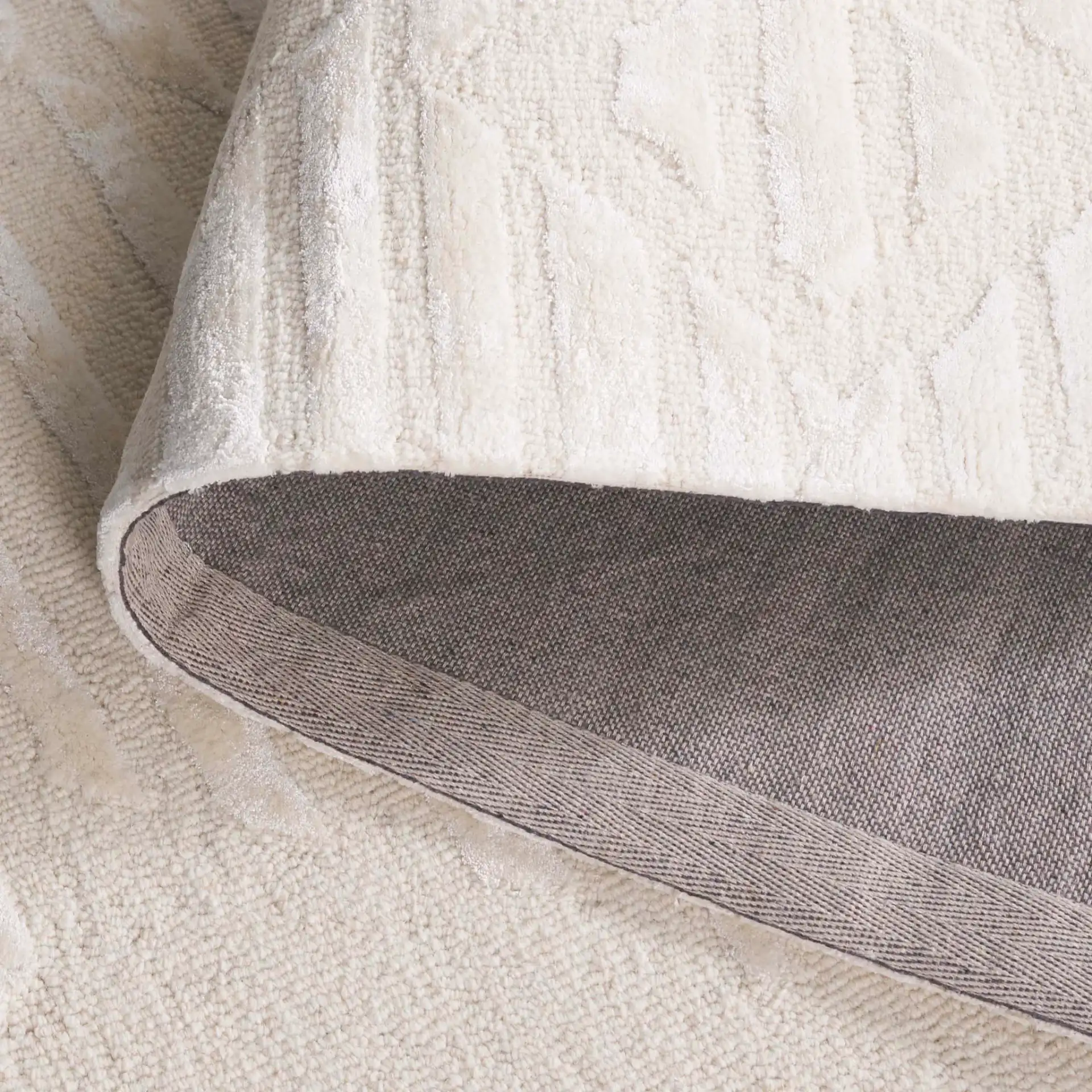 Soho Striped Diamond Hand-Tufted Rug in Ivory in a styled room
