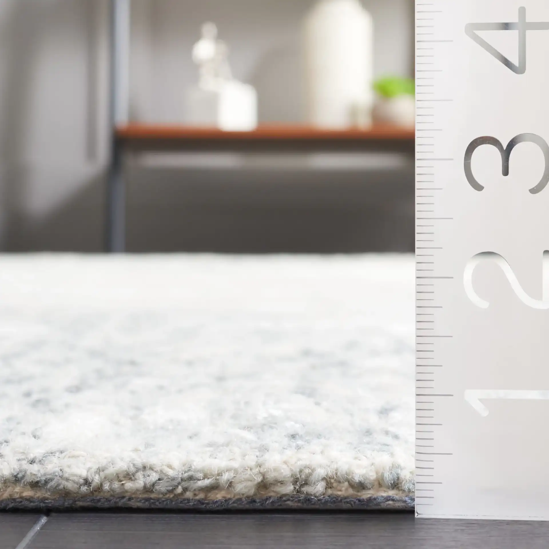 Soho Abstract Sunburst Hand-Tufted Rug in Gray / Ivory in a styled room