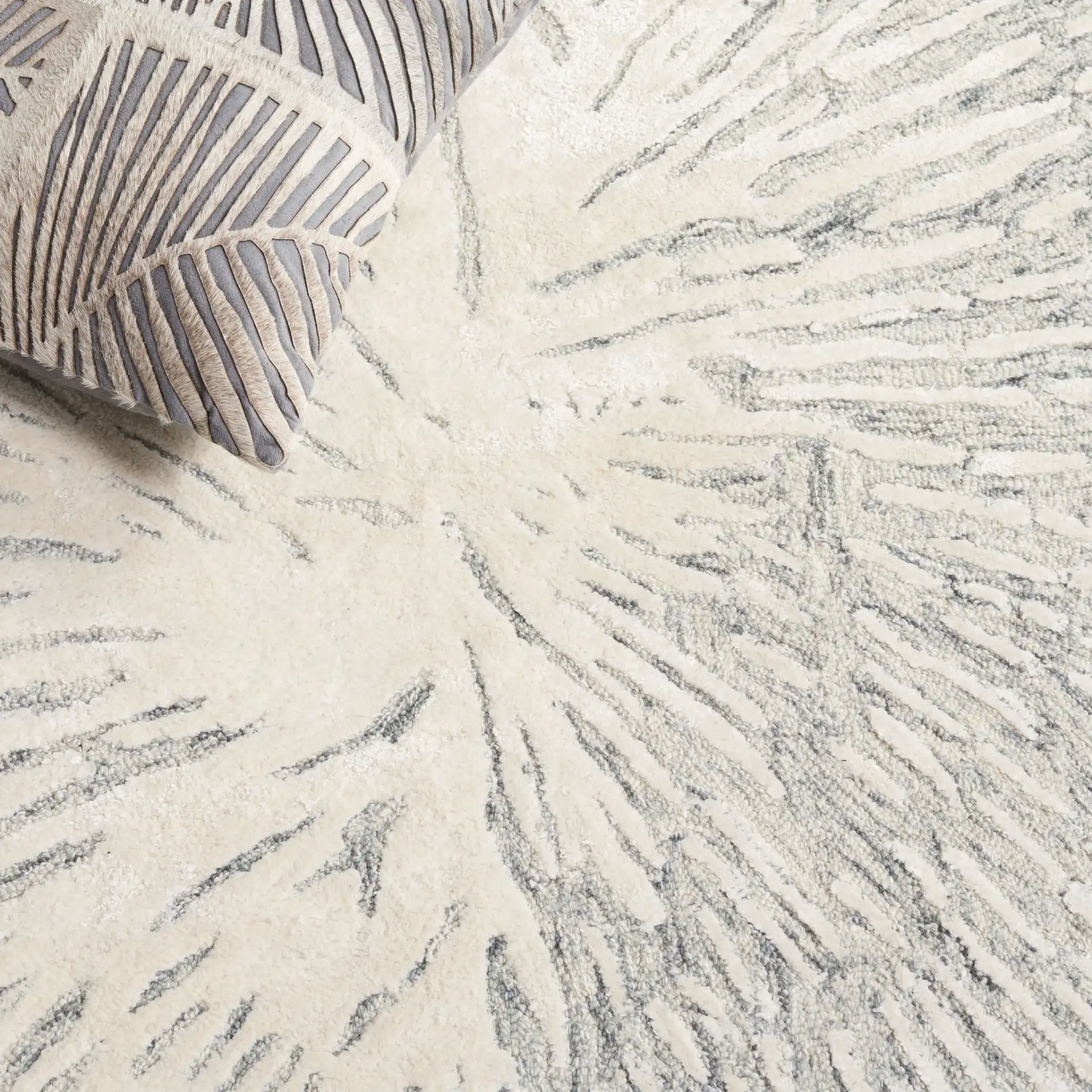 Soho Abstract Sunburst Hand-Tufted Rug in Gray / Ivory in a styled room