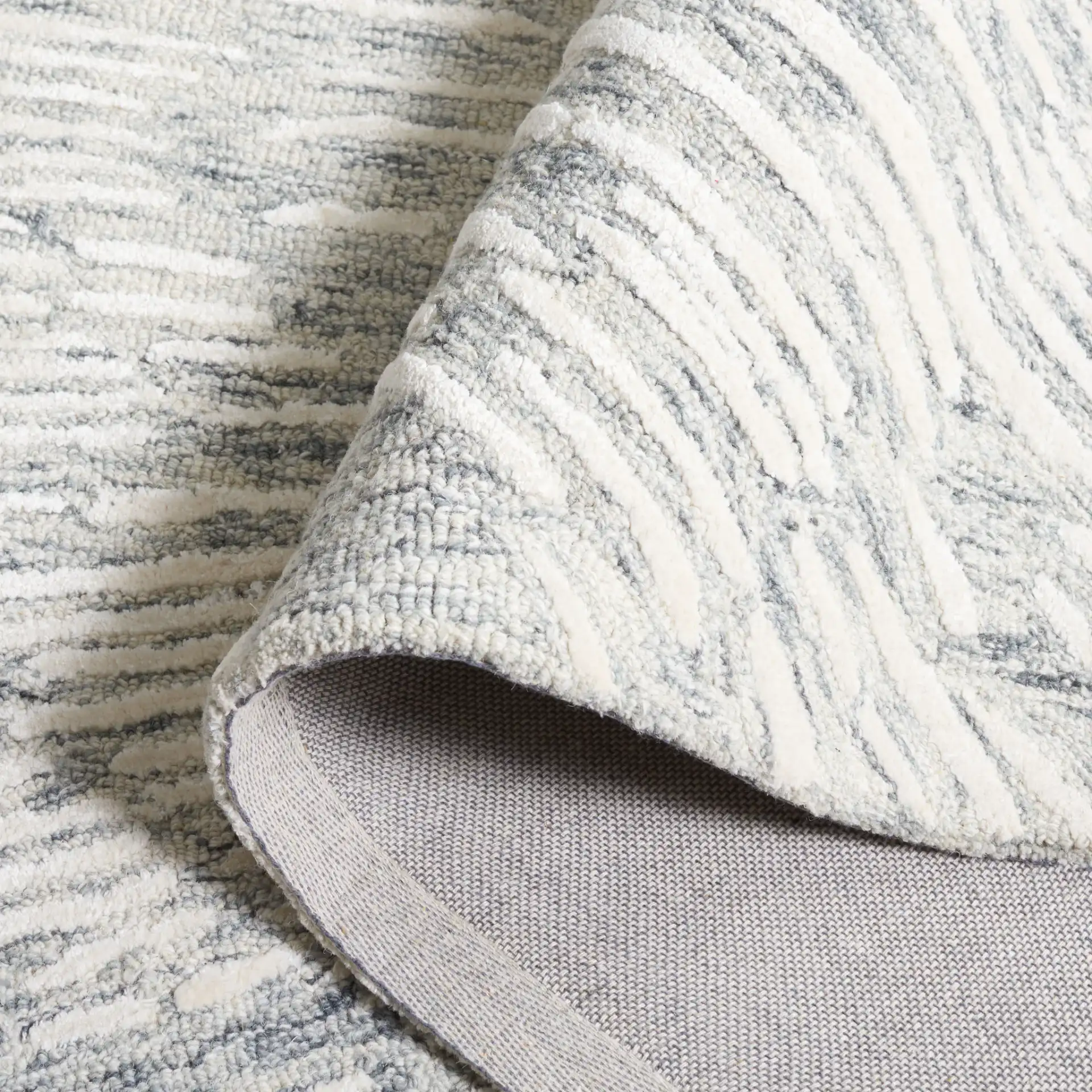 Soho Abstract Sunburst Hand-Tufted Rug in Gray / Ivory in a styled room