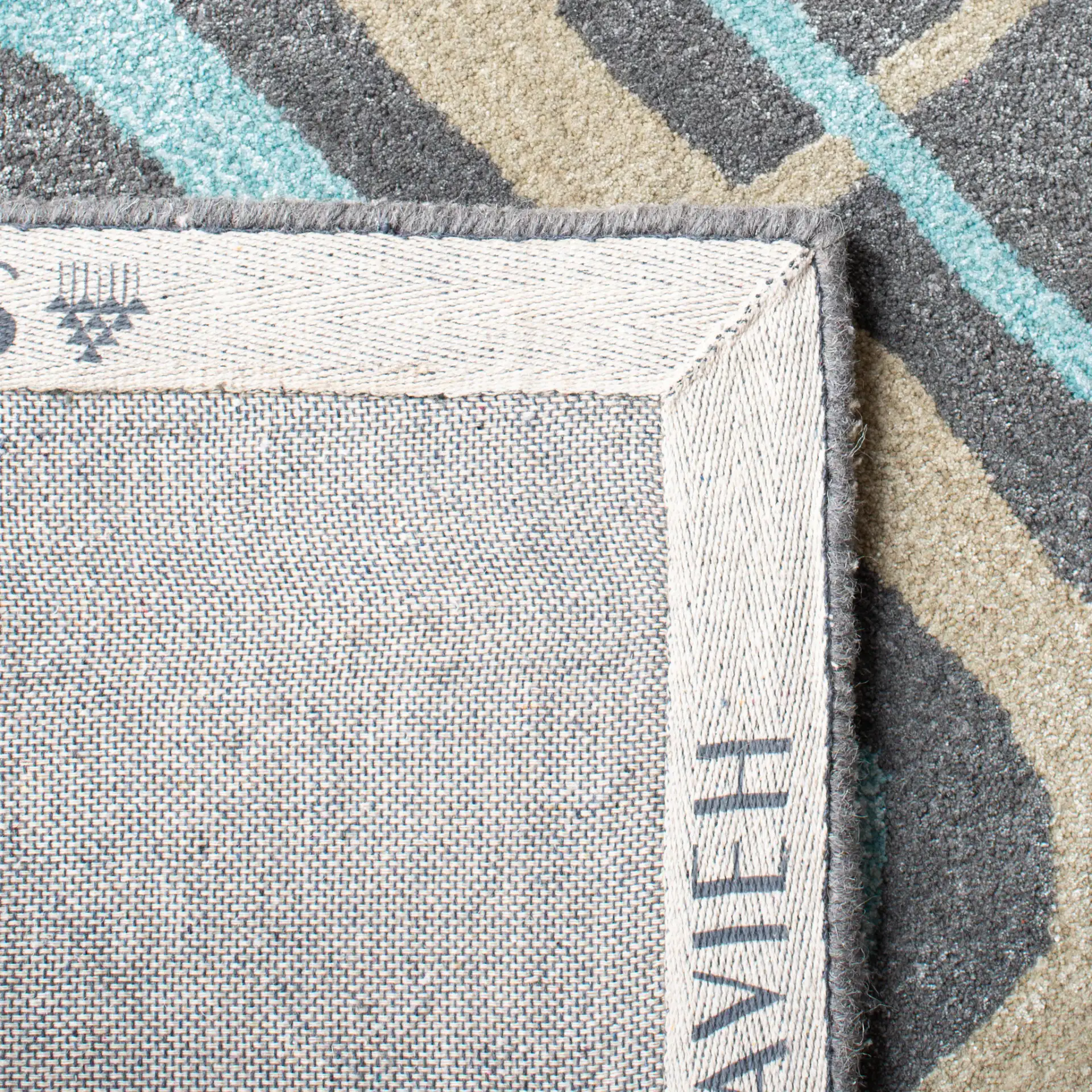 Soho Interlocking Diamond Hand-Tufted Rug in Gray / Multicolor in a styled room