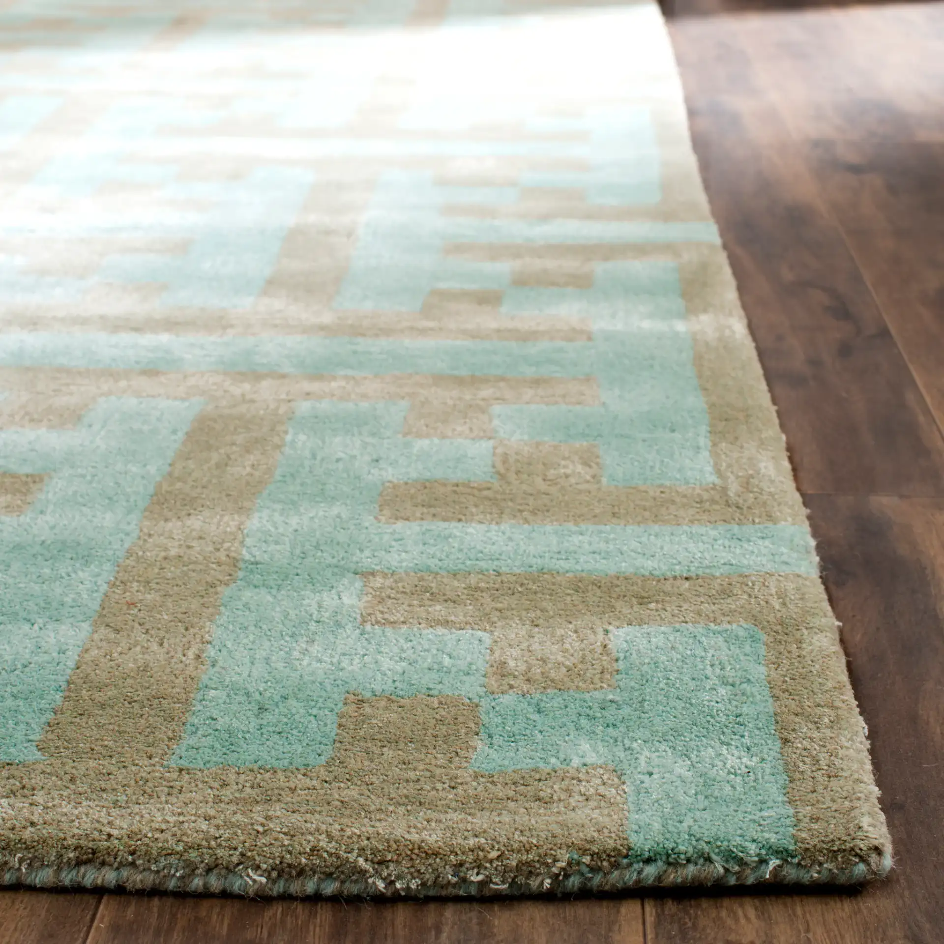 Soho Interlocking Maze Hand-Tufted Rug in Light Blue / Multicolor in a styled room