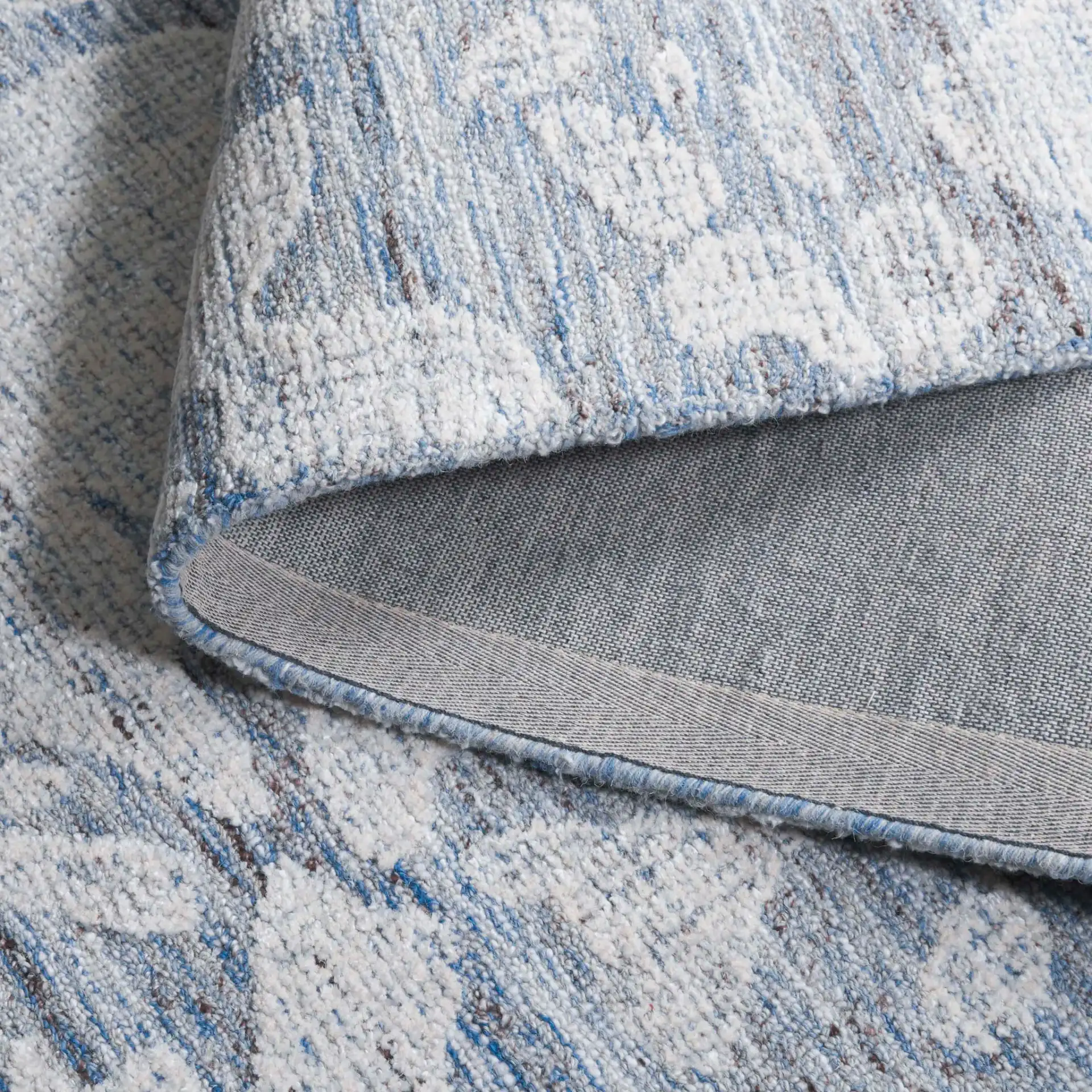 Soho Abstract Pebble Hand-Tufted Rug in Blue / Ivory in a styled room