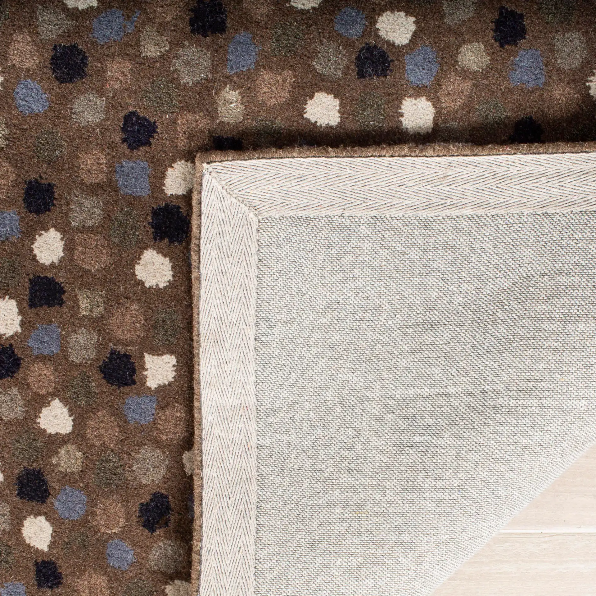 Soho Confetti Dots Hand-Tufted Rug in Dark Gray / Multicolor in a styled room