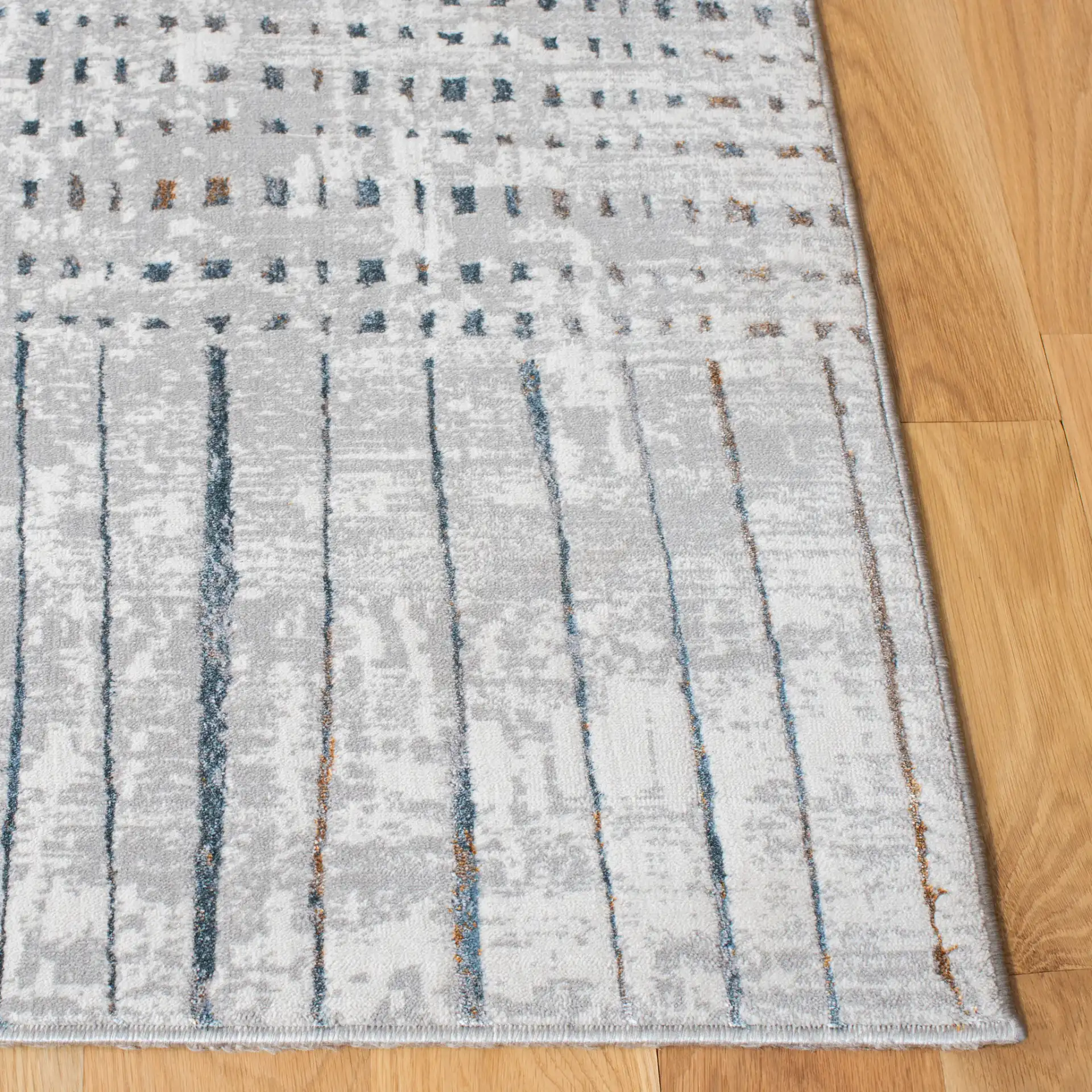 Sonoma Patchwork Grid Rug in Gray / Ivory in a styled room