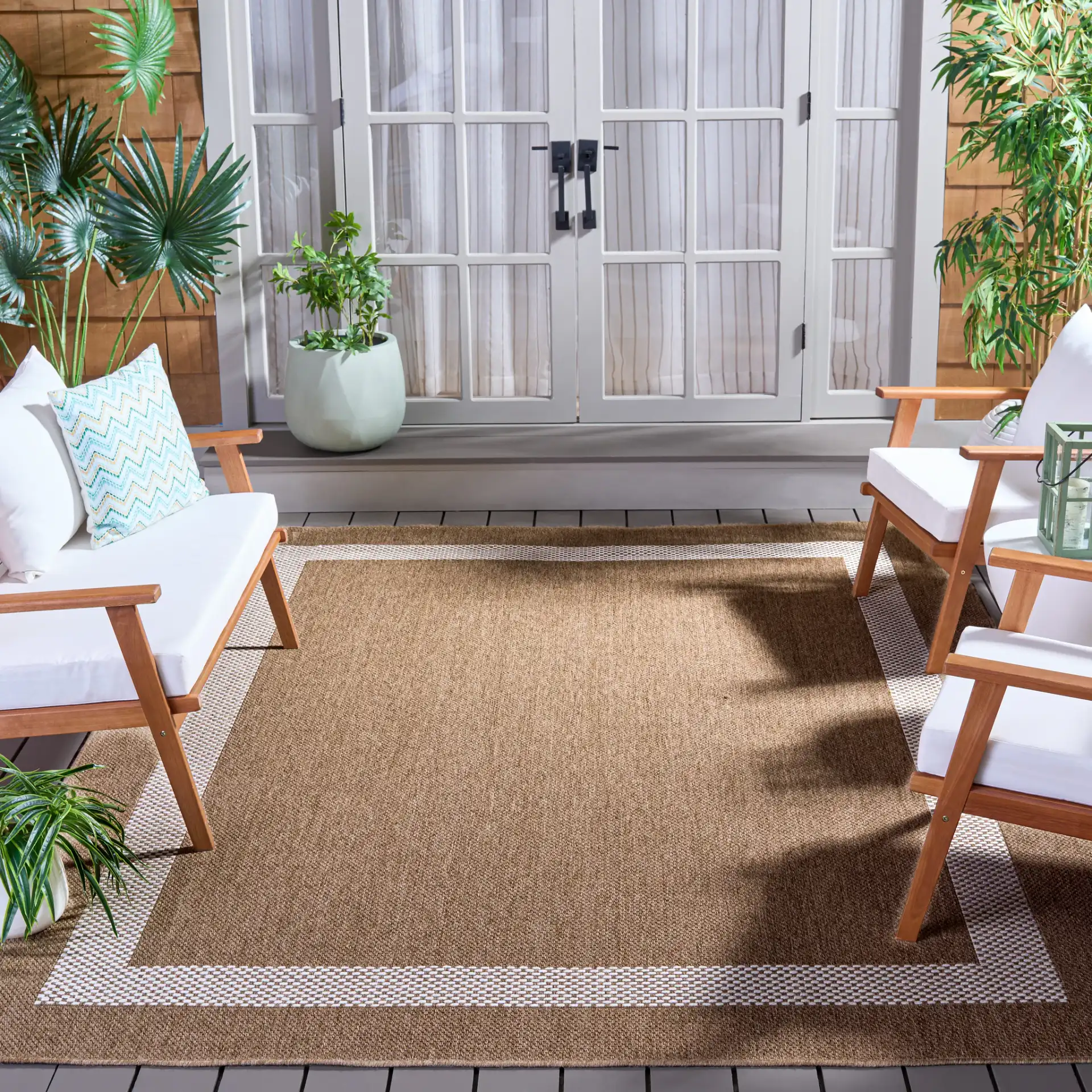 Sisal Performance Tulum Bordered Rug in Natural / Ivory in a styled room