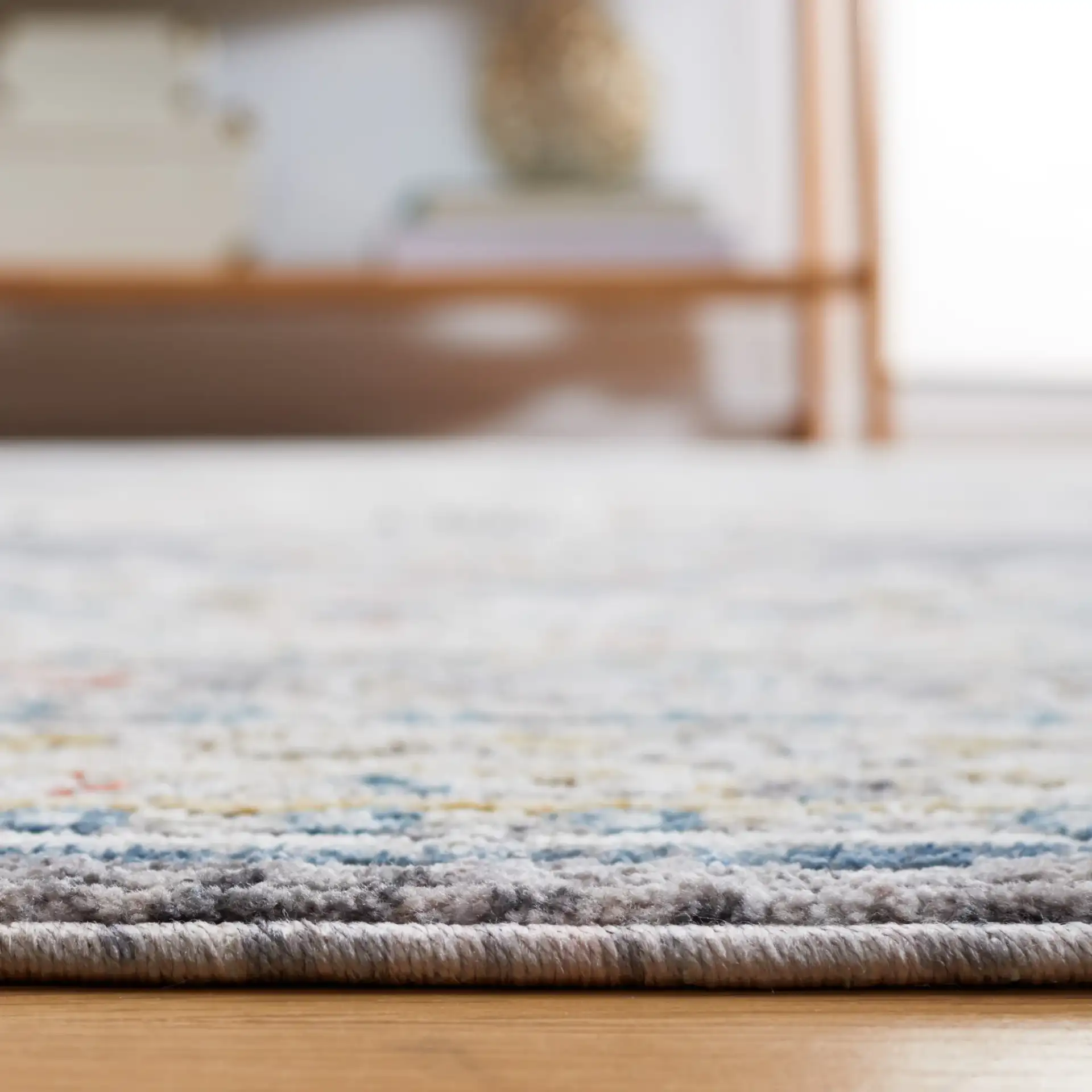 Sierra Medallion Bordered Rug in Ivory / Gray in a styled room