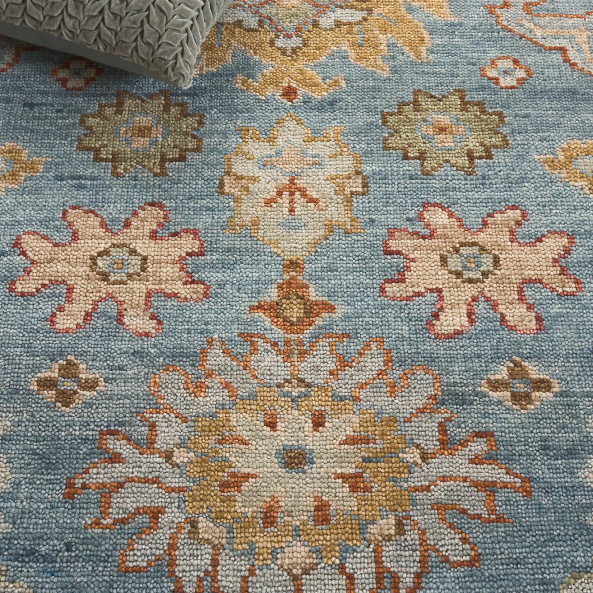 Samarkand Palmette Floral Bordered Hand-Knotted Wool Rug in Blue in a styled room