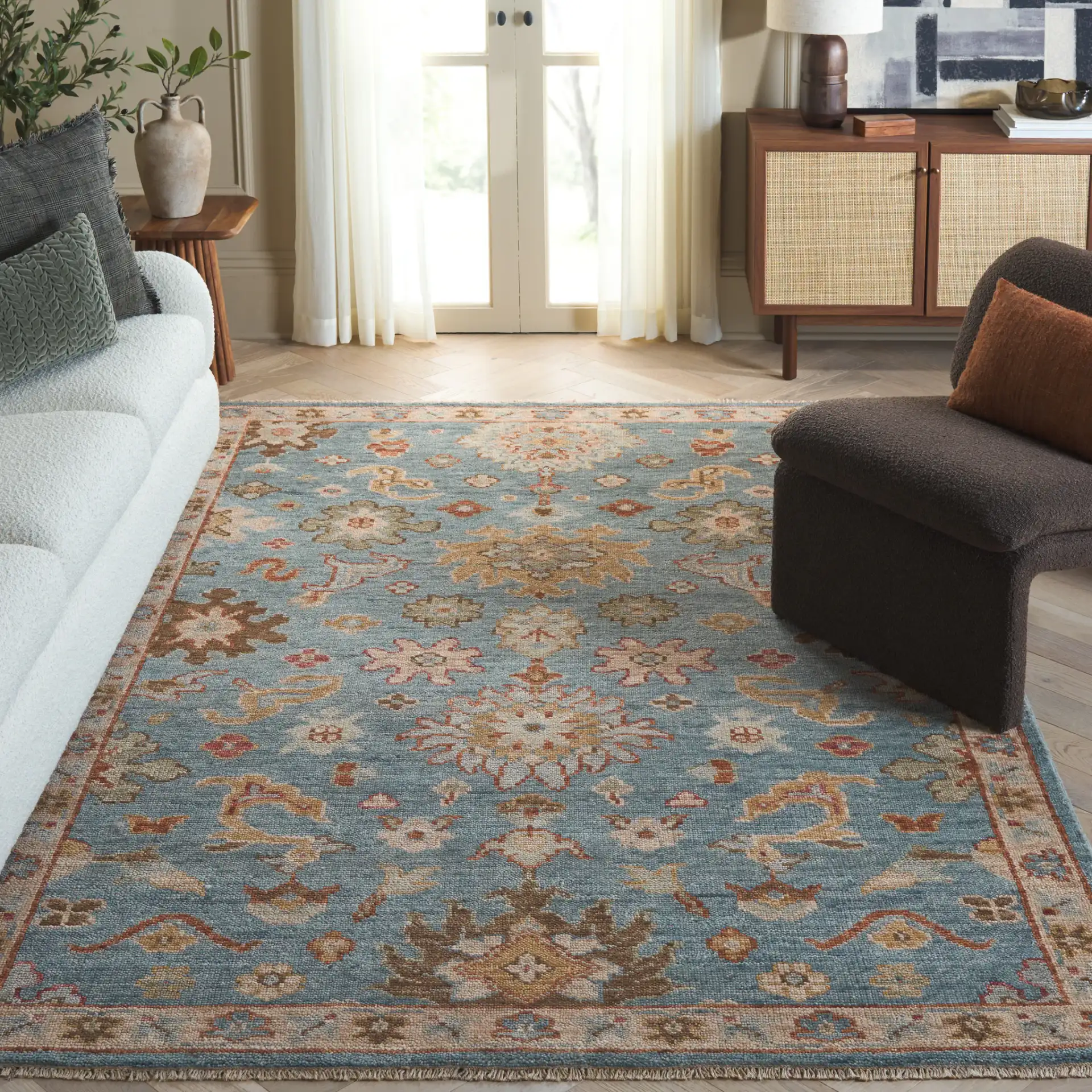 Samarkand Palmette Floral Bordered Hand-Knotted Wool Rug in Blue in a styled room