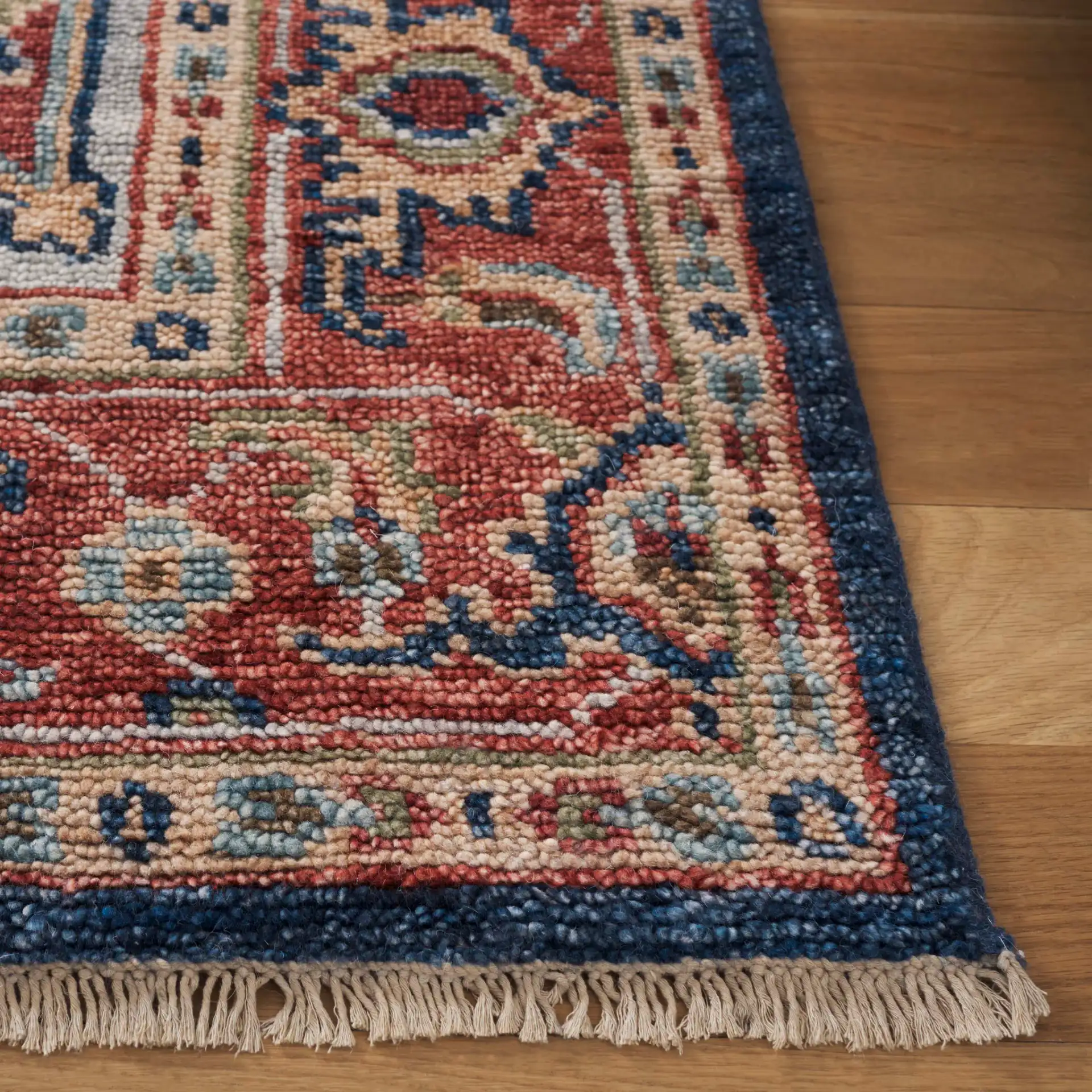 Samarkand Layered Medallion Hand-Knotted Wool Rug in Navy / Rust in a styled room