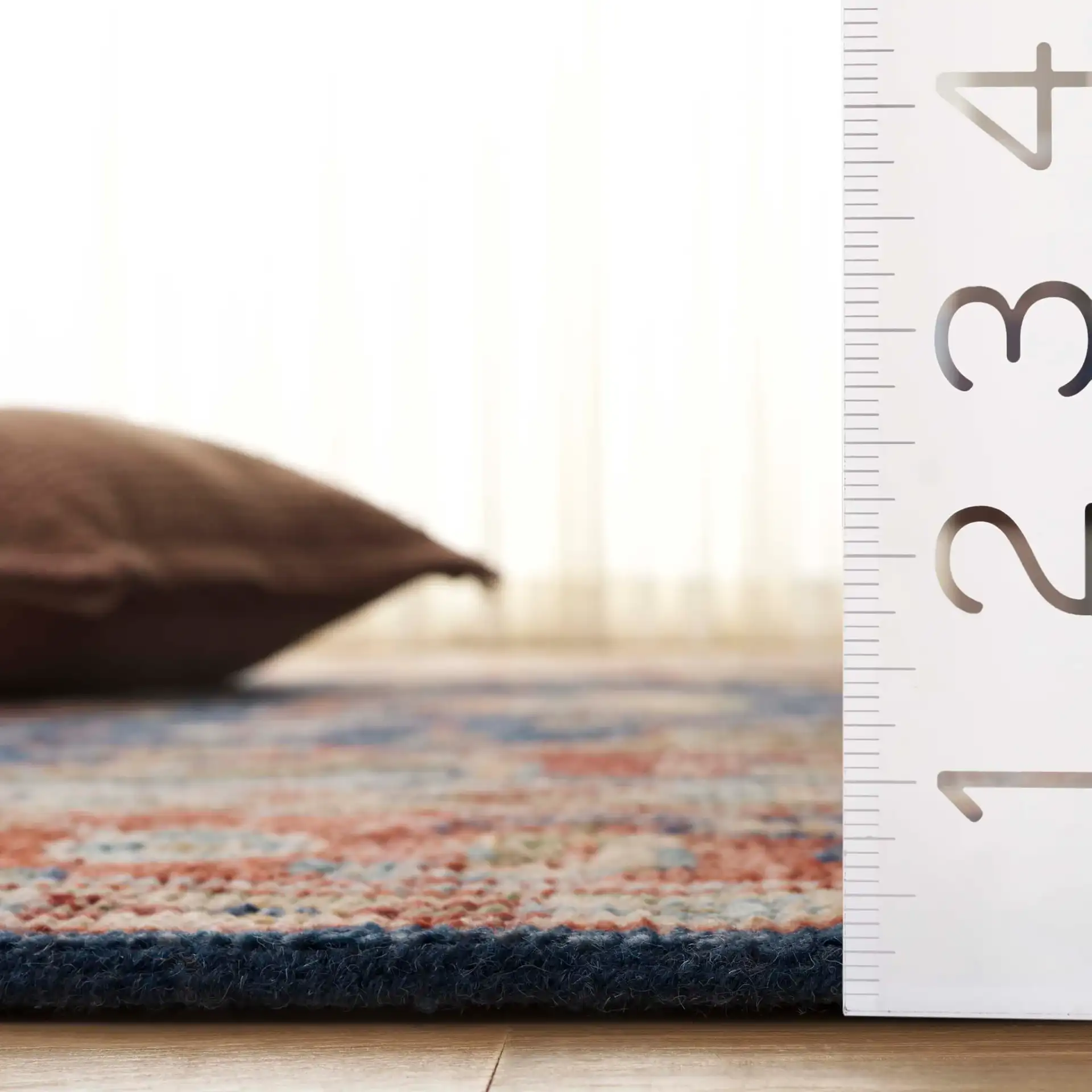 Samarkand Layered Medallion Hand-Knotted Wool Rug in Navy / Rust in a styled room