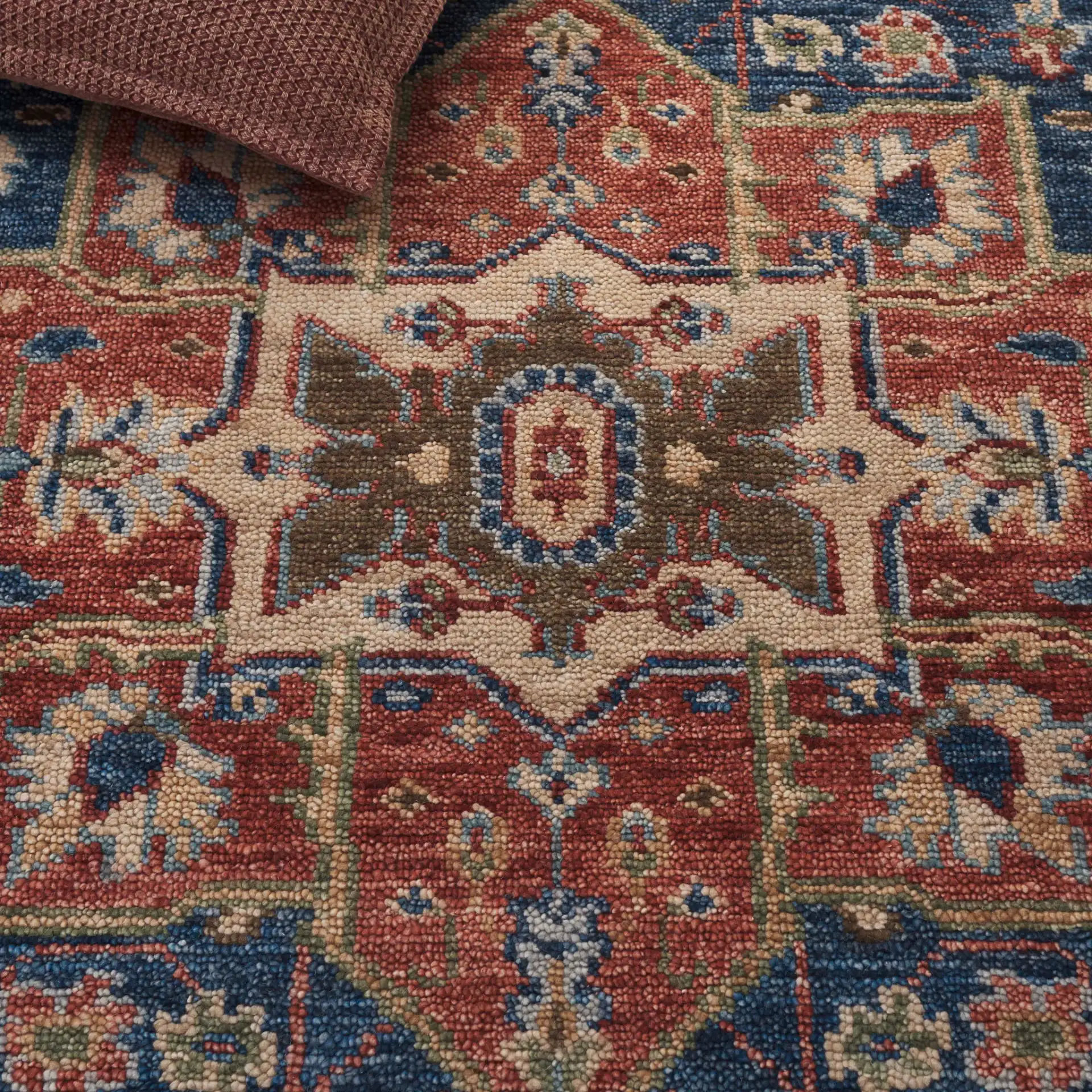 Samarkand Layered Medallion Hand-Knotted Wool Rug in Navy / Rust in a styled room