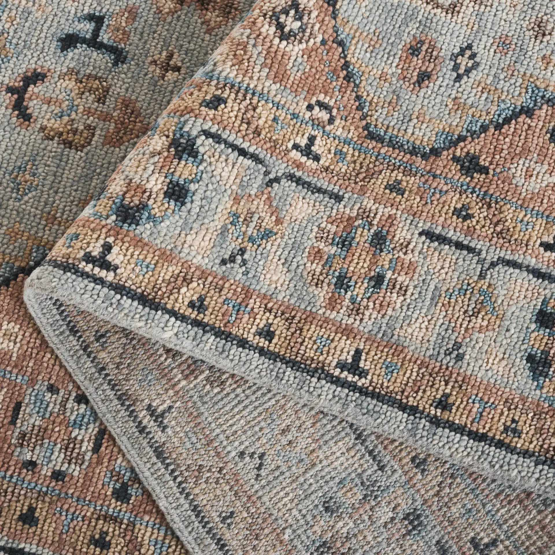 Samarkand Tribal Medallion Bordered Hand-Knotted Wool Rug in Light Blue / Beige in a styled room