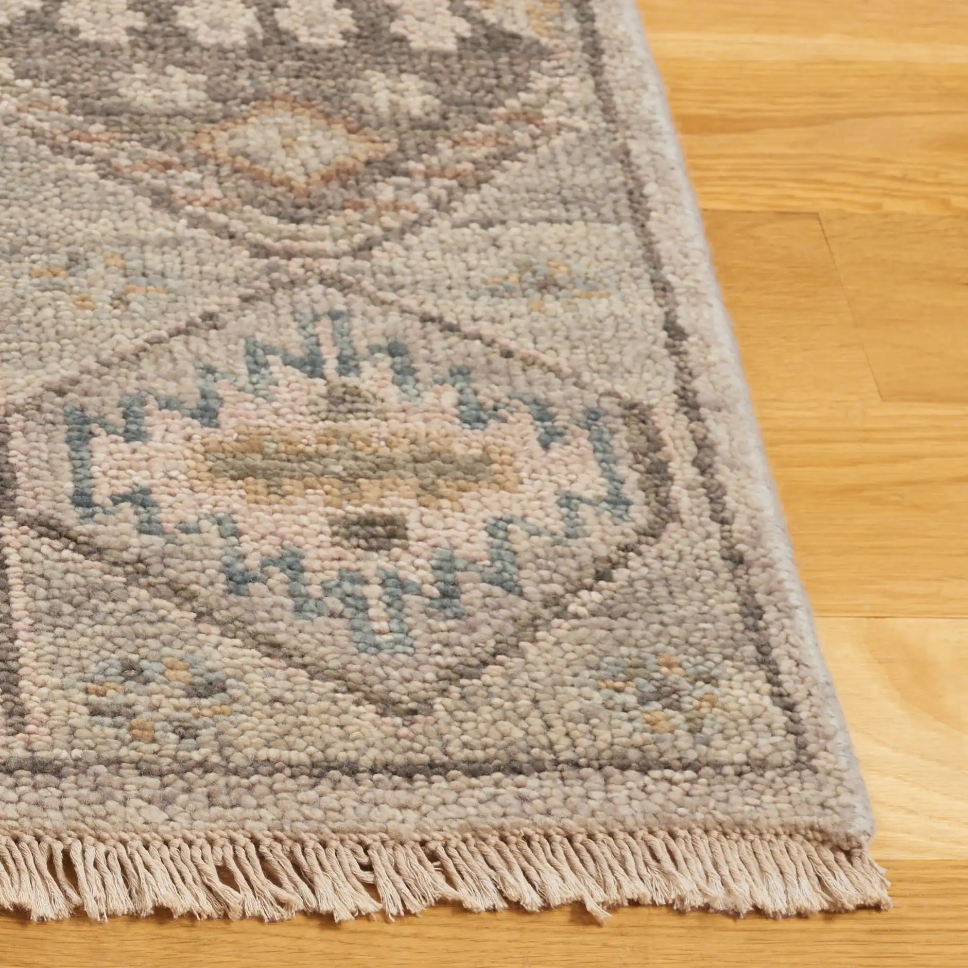Samarkand Faded Tribal Medallion Hand-Knotted Wool Rug in Gray / Ivory in a styled room