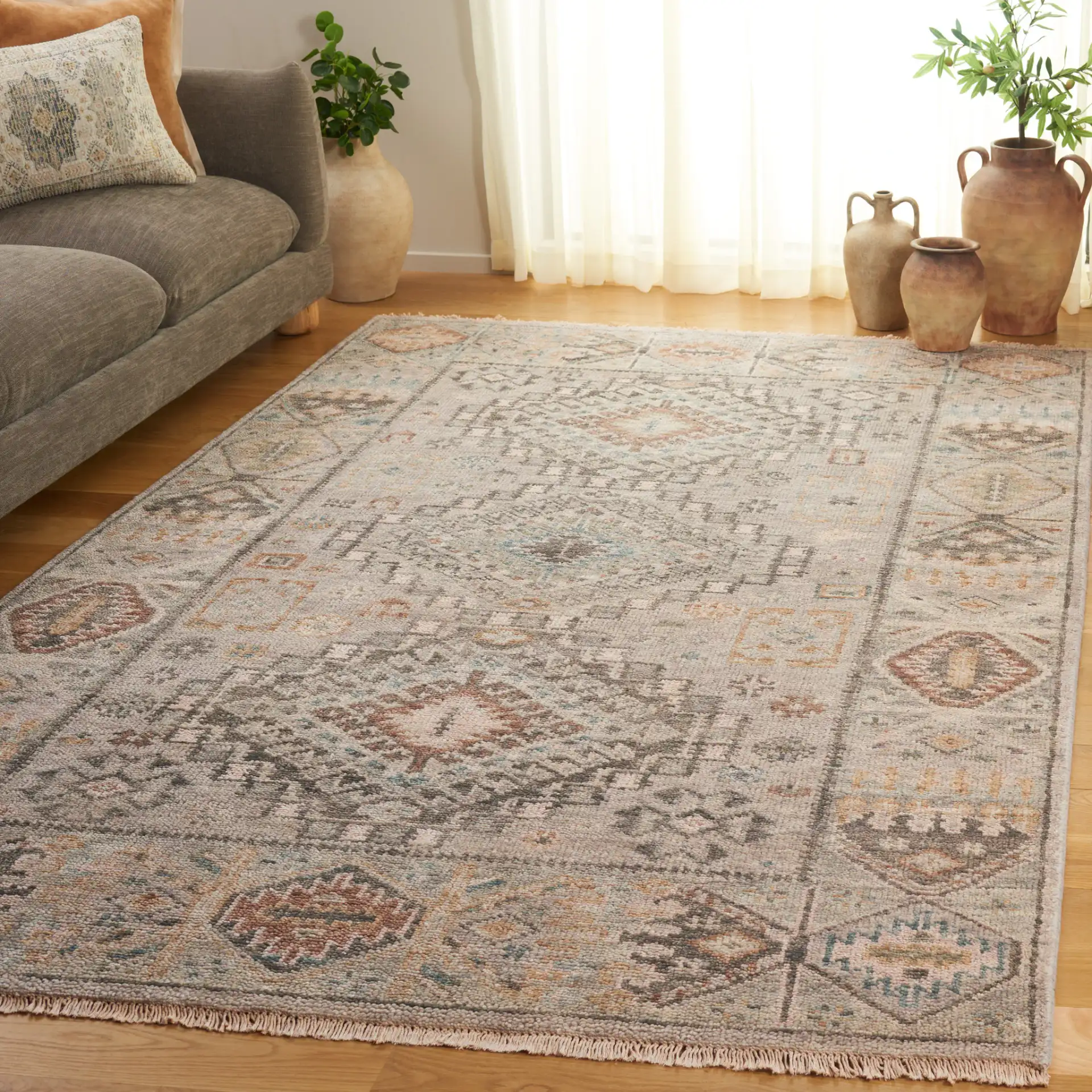 Samarkand Faded Tribal Medallion Hand-Knotted Wool Rug in Gray / Ivory in a styled room