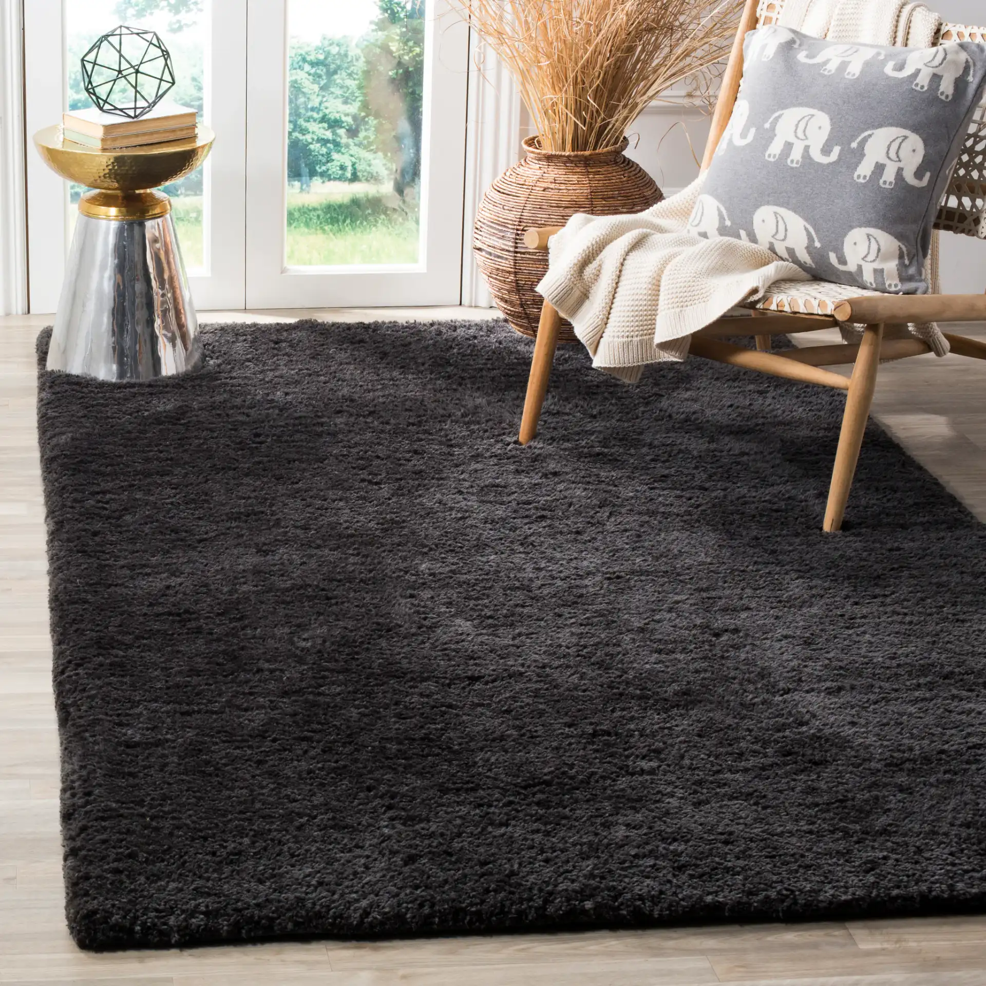 Sheep Solid Hand-Woven Shag Rug in Charcoal in a styled room