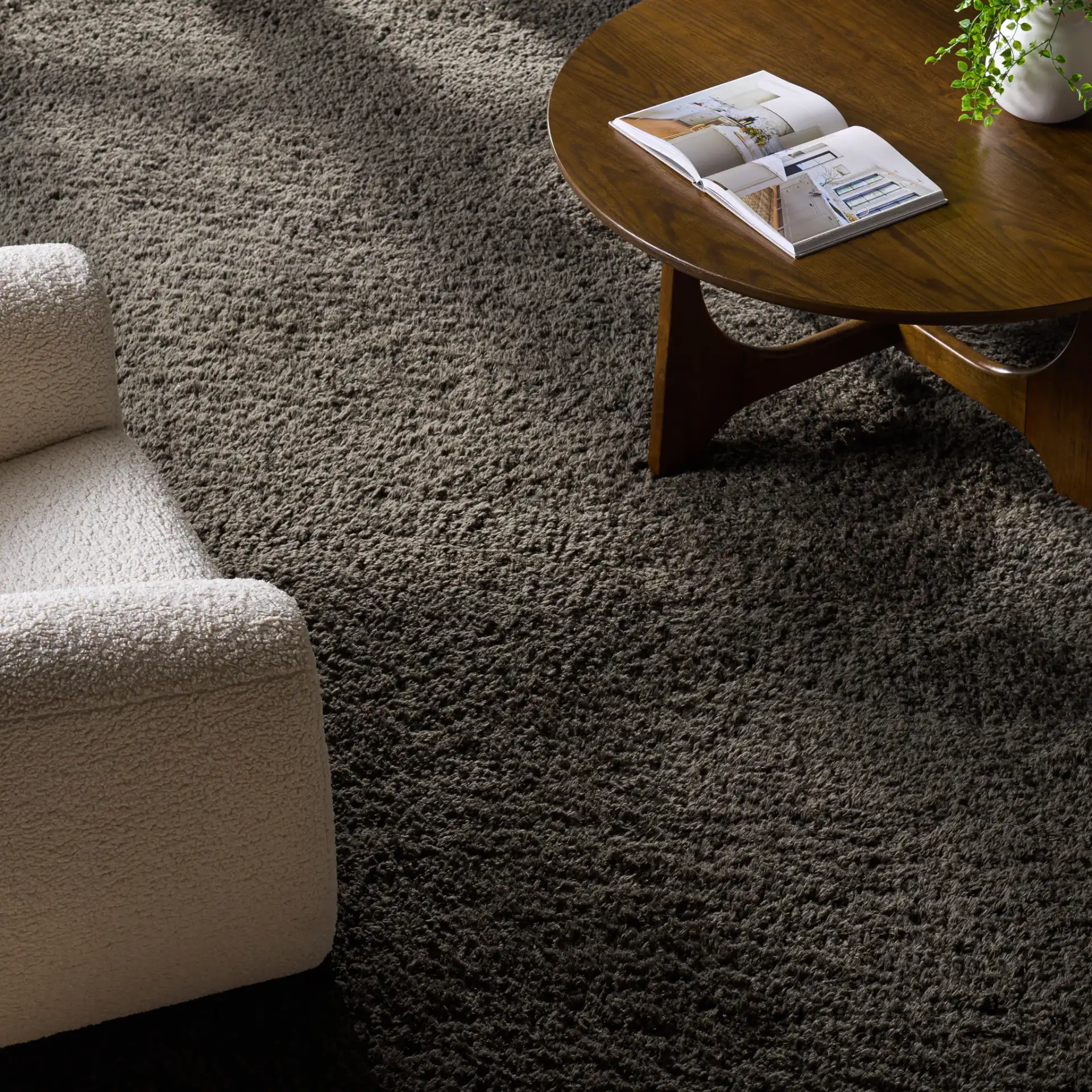 Sheep Solid Hand-Woven Shag Rug in Charcoal in a styled room