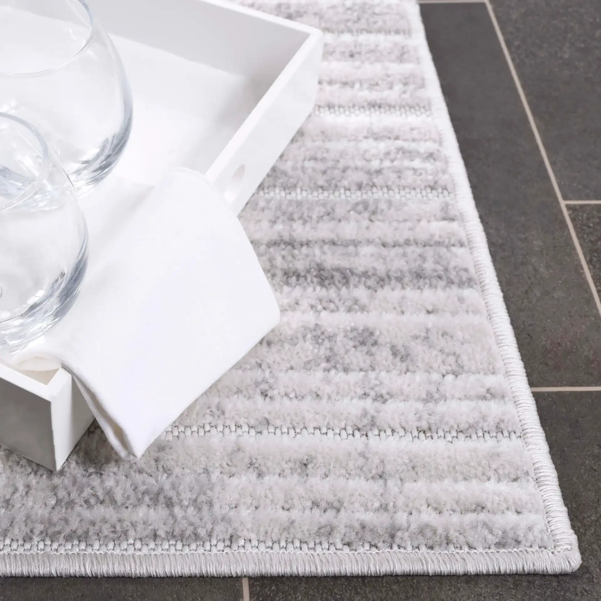Stella Striated Stripe Outdoor Rug in Ivory / Gray in a styled room