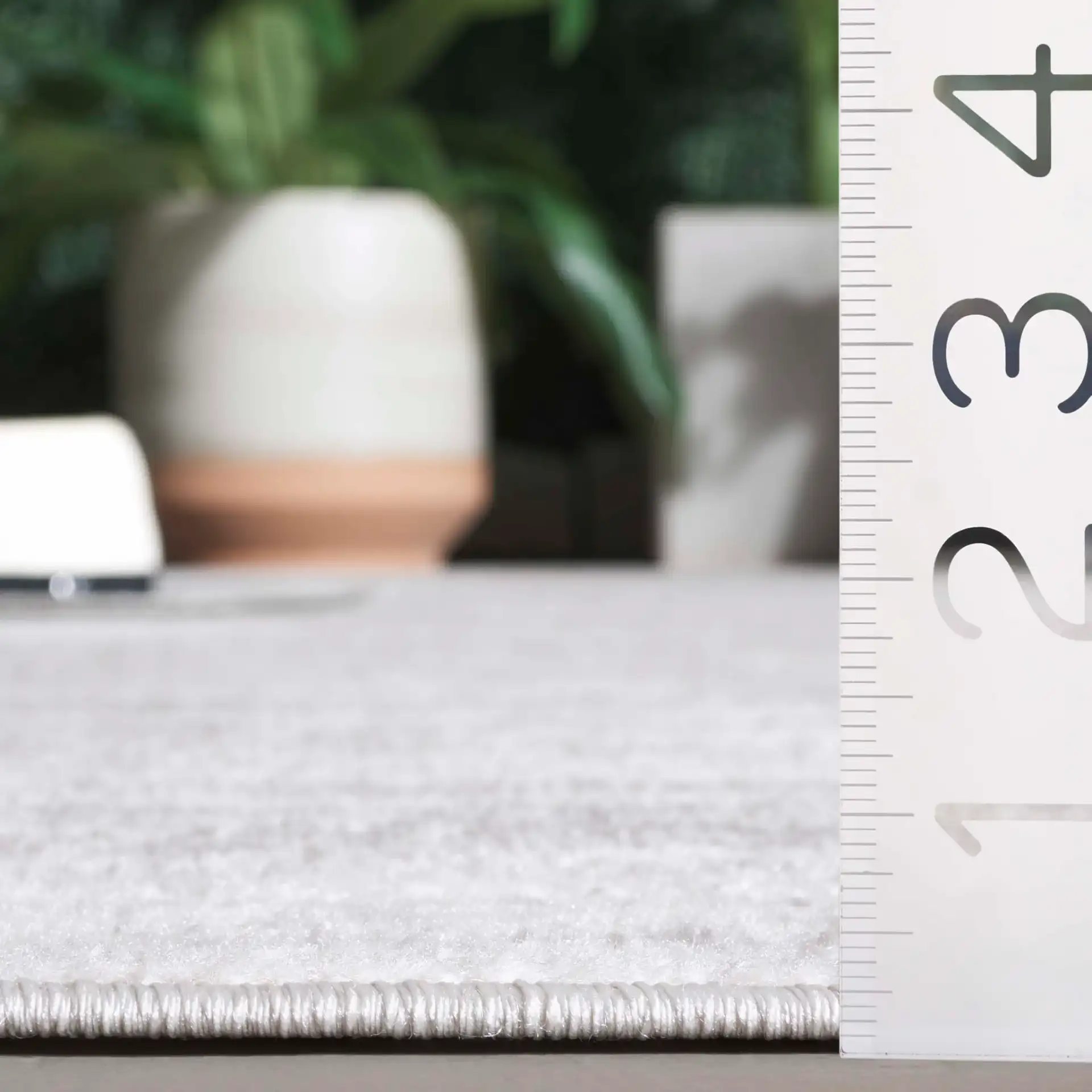 Stella Striated Stripe Outdoor Rug in Ivory / Gray in a styled room