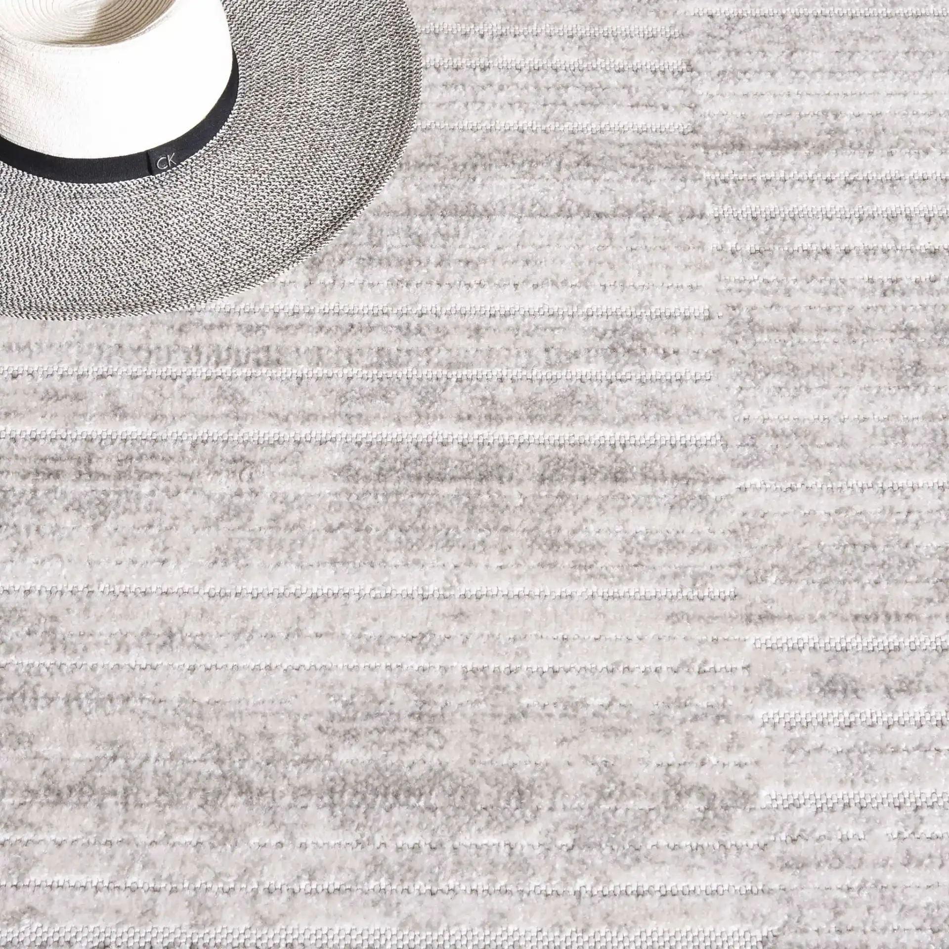 Stella Striated Stripe Outdoor Rug in Ivory / Gray in a styled room