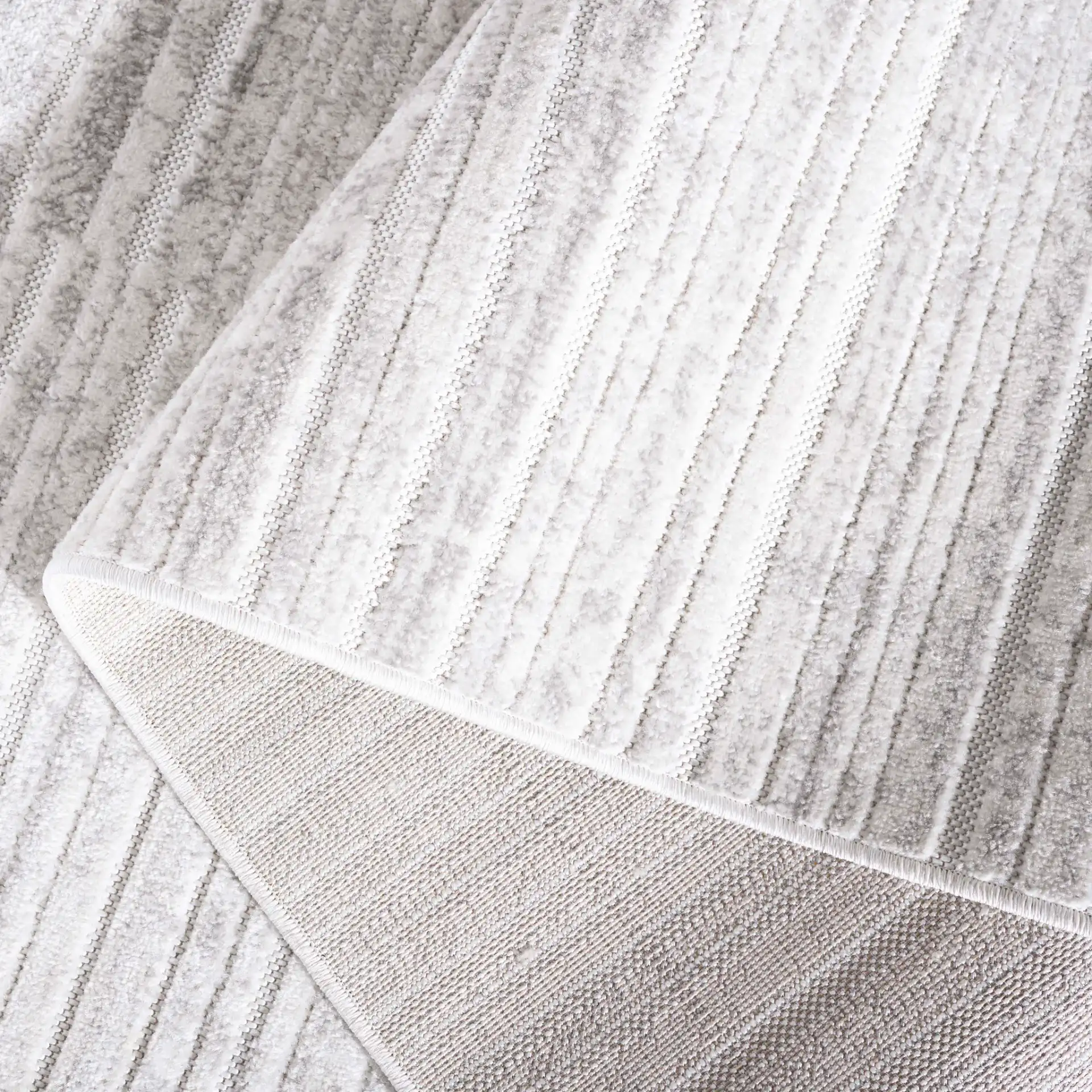 Stella Striated Stripe Outdoor Rug in Ivory / Gray in a styled room
