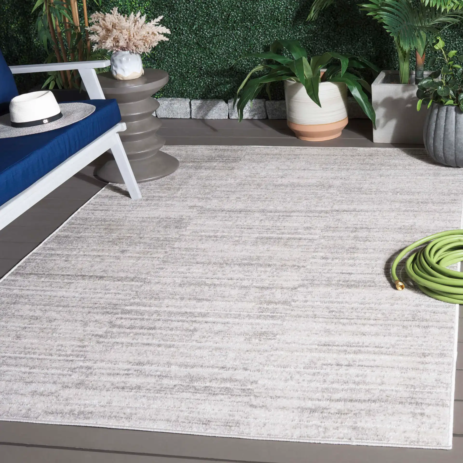 Stella Striated Stripe Outdoor Rug in Ivory / Gray in a styled room