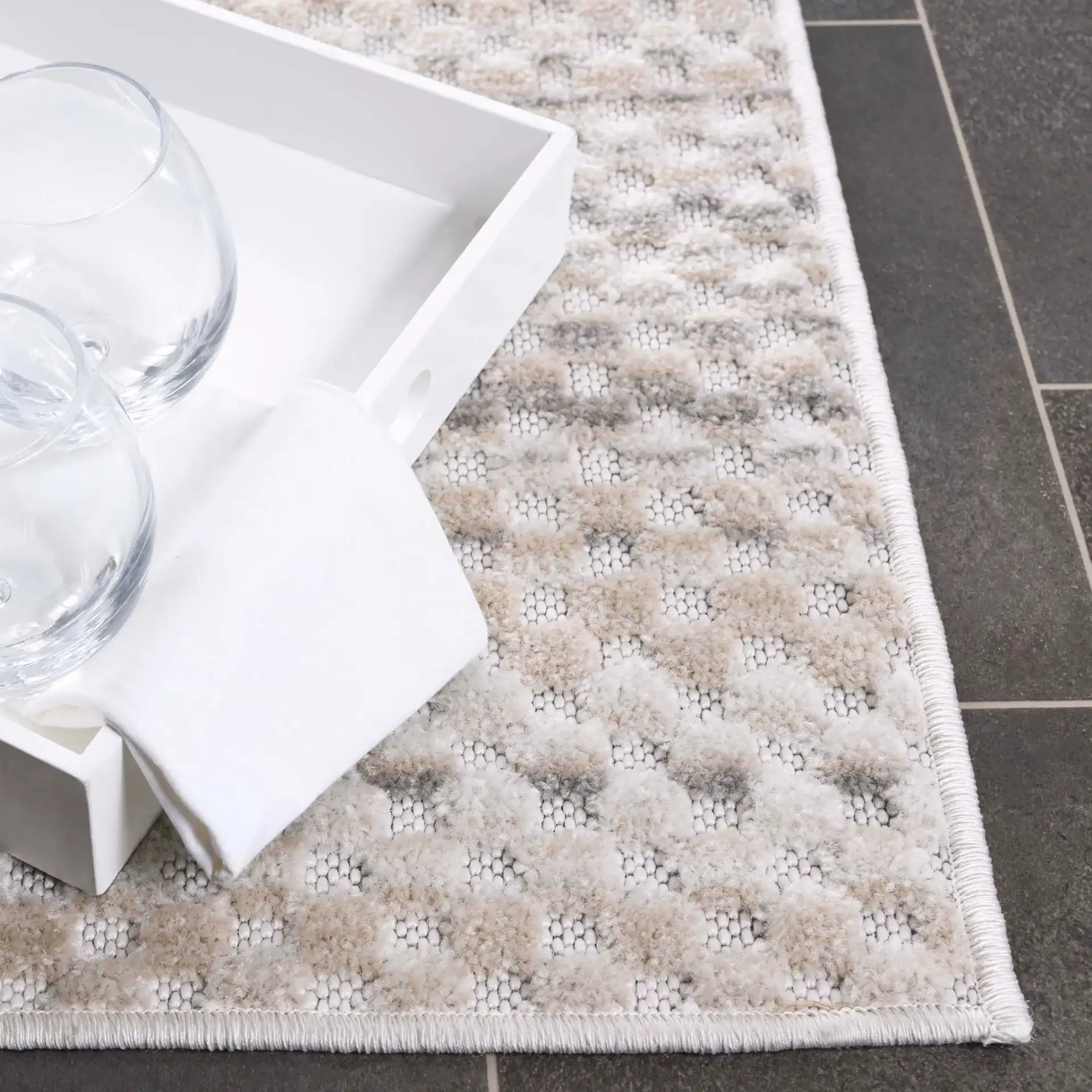Stella Dotted Stripe Outdoor Rug in Beige / Gray in a styled room