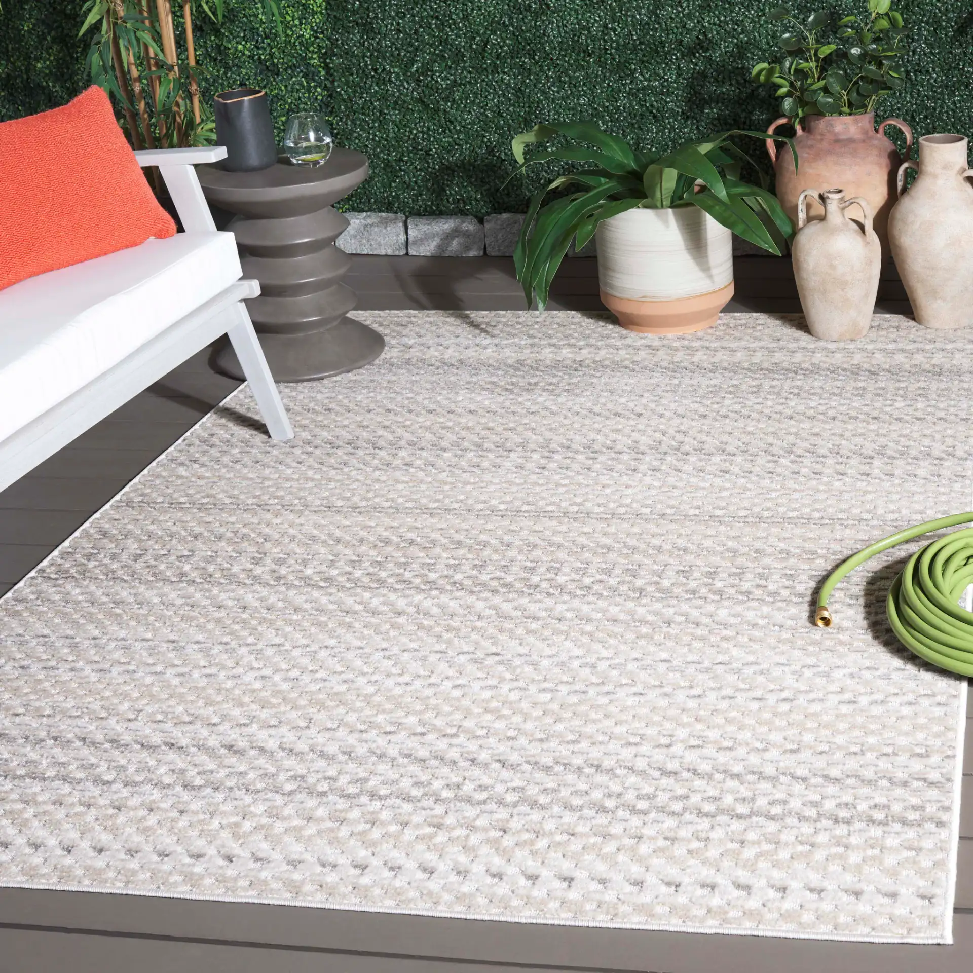 Stella Dotted Stripe Outdoor Rug in Beige / Gray in a styled room