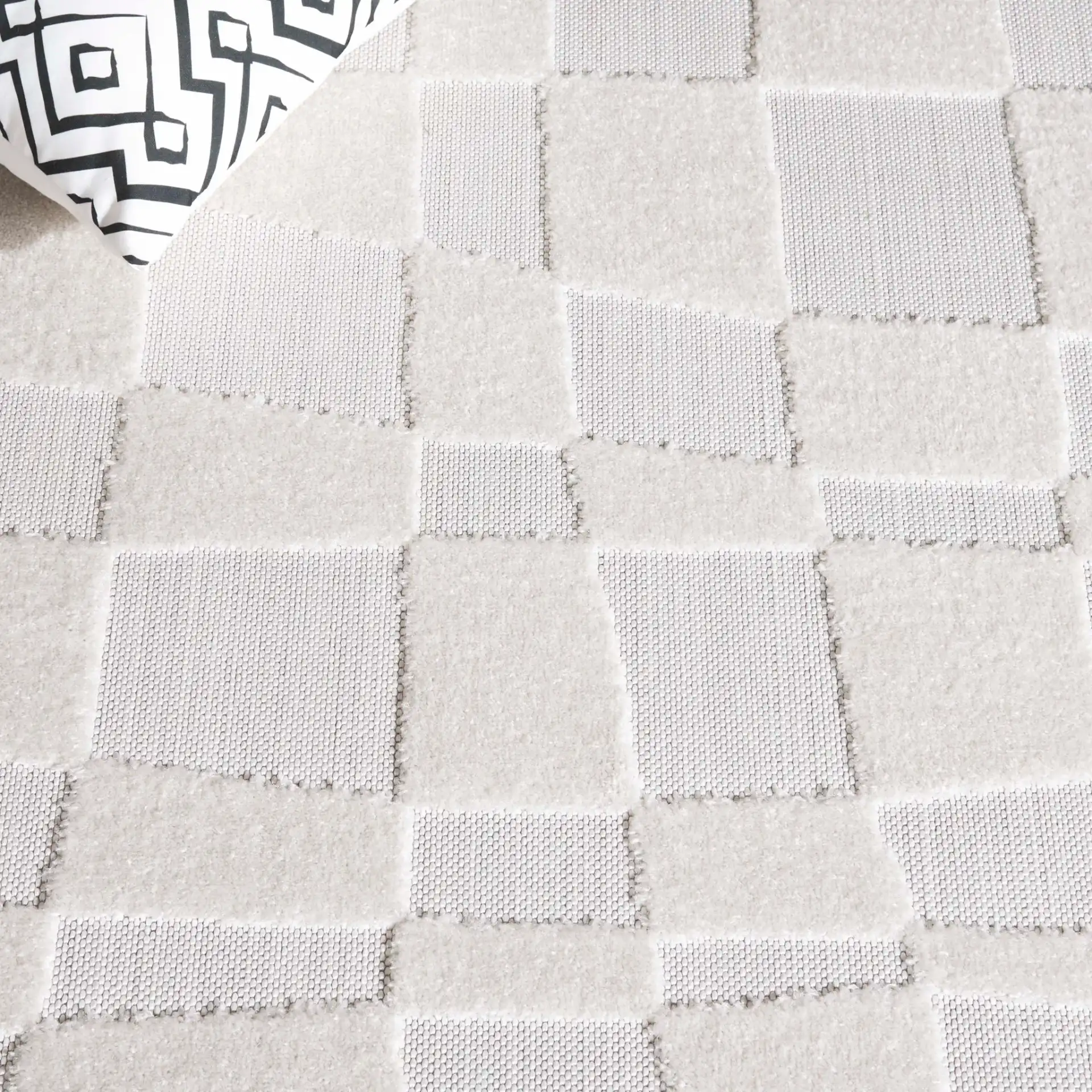 Stella Wavy Grid Outdoor Rug in Ivory in a styled room