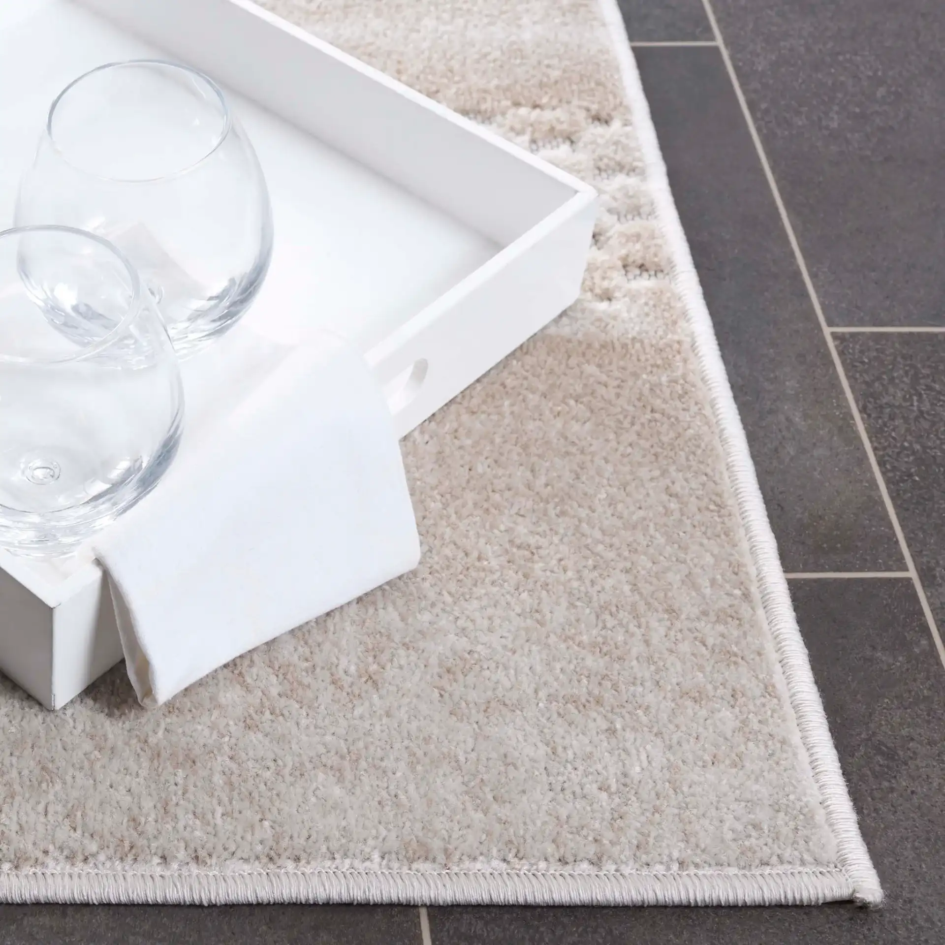 Stella Banded Abstract Outdoor Rug in Beige / Gray in a styled room